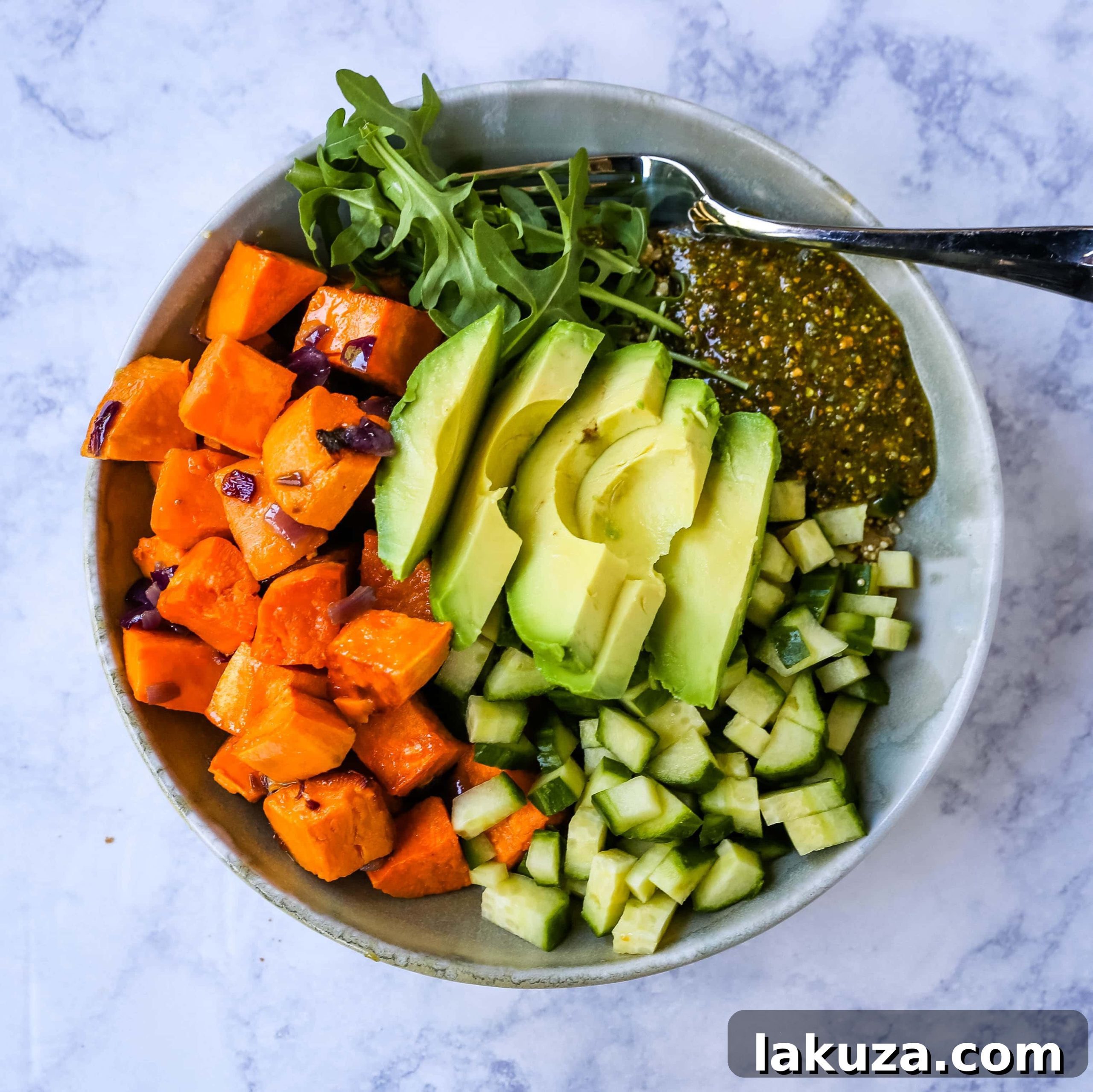 Vibrant Pistachio Pesto Power Bowl 2 Buddha Bowl with Pistachio Pesto: A vibrant, healthy vegan bowl featuring roasted sweet potatoes, onions, fresh avocado, crisp cucumbers, peppery arugula, nutritious quinoa, and a flavorful homemade pistachio pesto. Perfect for a nourishing, plant-based meal.