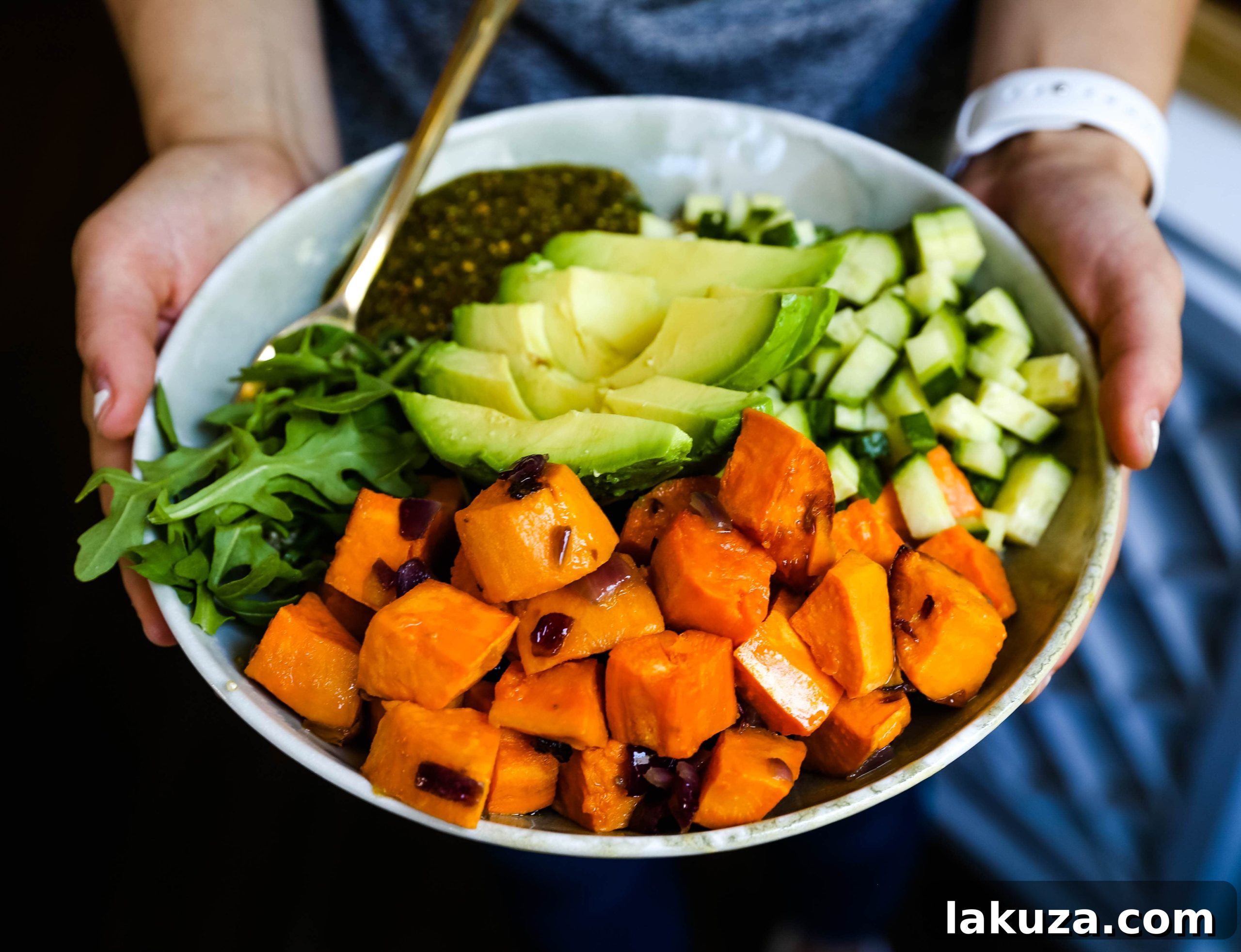 Vibrant Pistachio Pesto Power Bowl 3 A close-up of a colorful Buddha Bowl with Pistachio Pesto, showcasing layers of roasted sweet potatoes, quinoa, avocado slices, and green pesto drizzle.