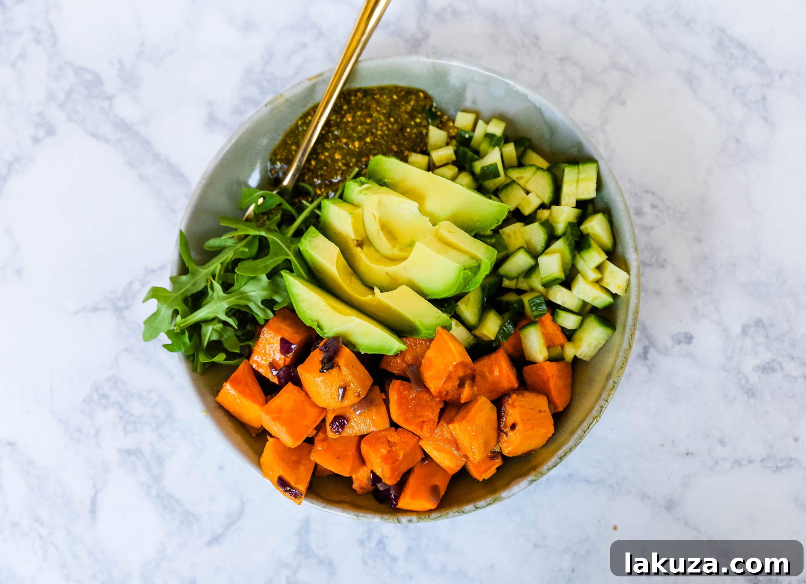 Vibrant Pistachio Pesto Power Bowl 5 A vibrant close-up of fresh avocado slices and diced cucumber, essential fresh components for a healthy Buddha Bowl.