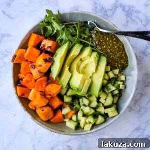 Vibrant Pistachio Pesto Power Bowl 8 Buddha Bowl with Pistachio Pesto: A healthy vegan bowl with roasted sweet potatoes, onions, fresh avocado, cucumbers, arugula, quinoa, and homemade pistachio pesto.