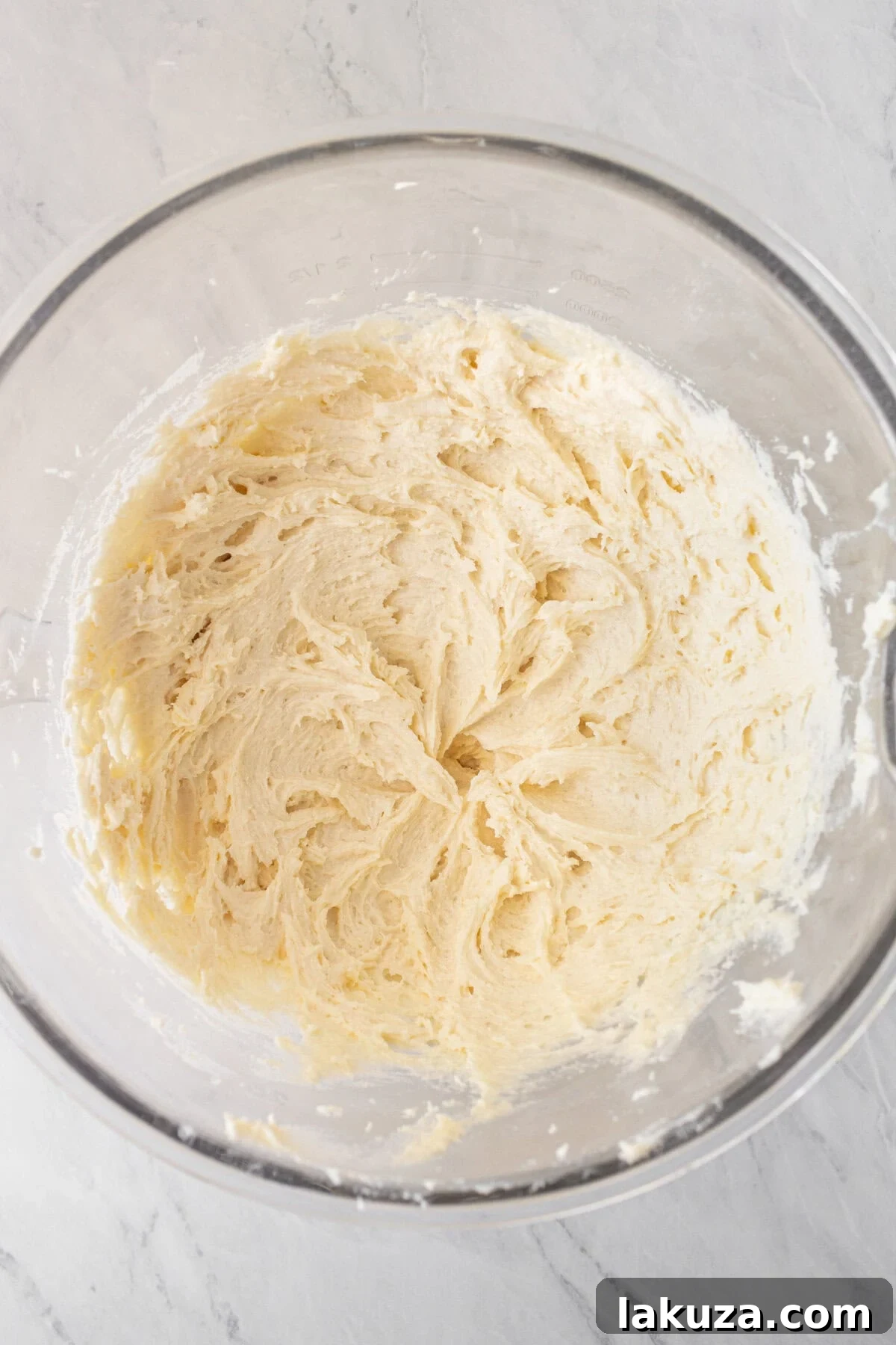 Smooth vanilla cake batter in a mixing bowl, ready for baking.