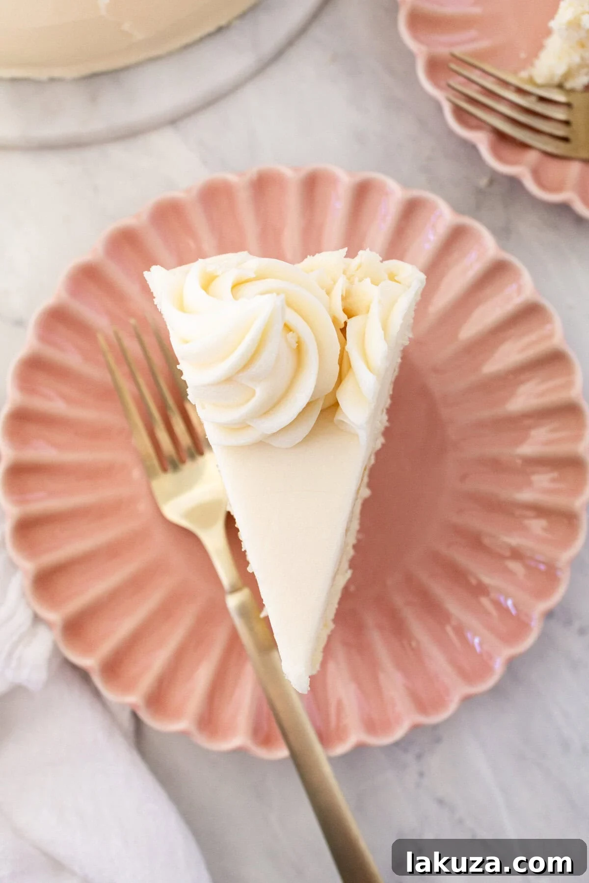 Close-up of a perfectly decorated vanilla cake with intricate frosting details.