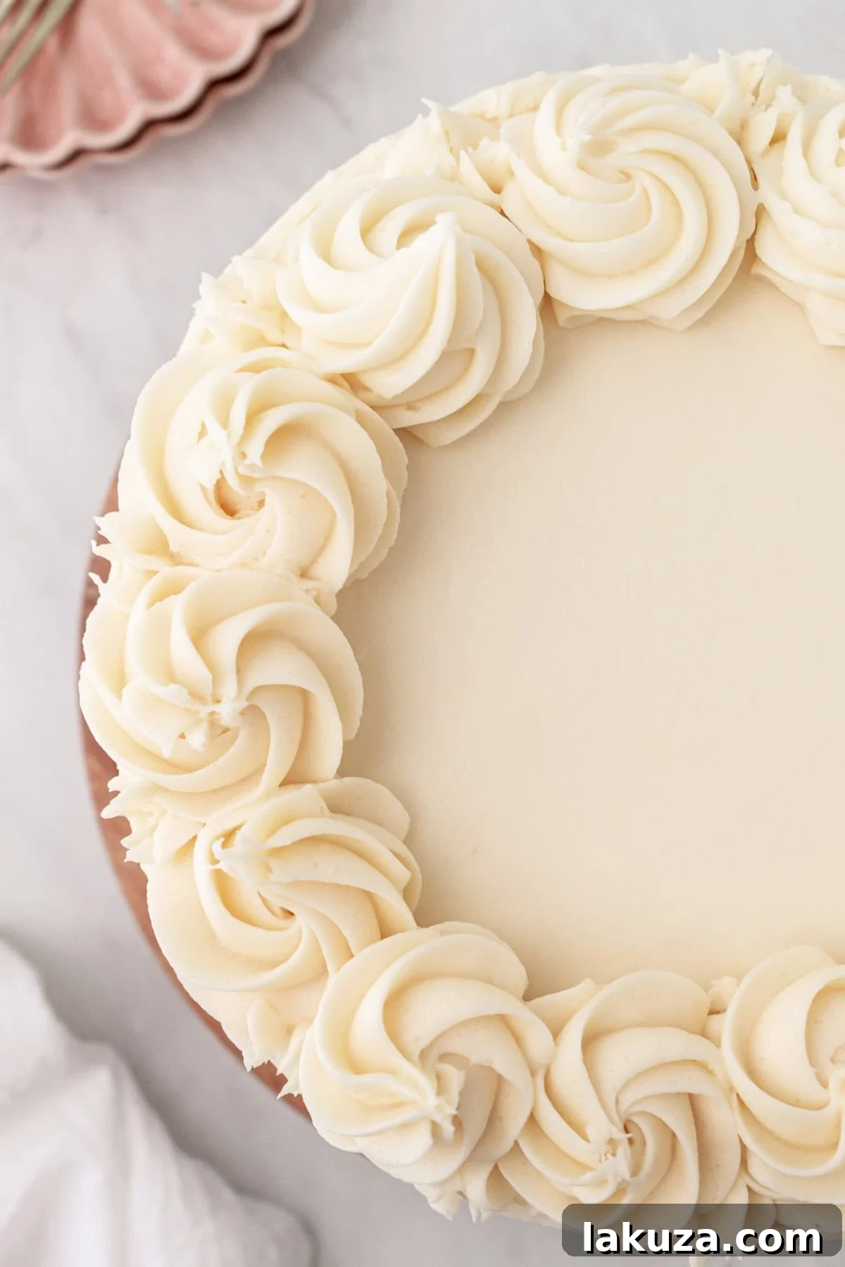 Two-tier vanilla cake with fluffy vanilla bean buttercream, elegantly frosted.