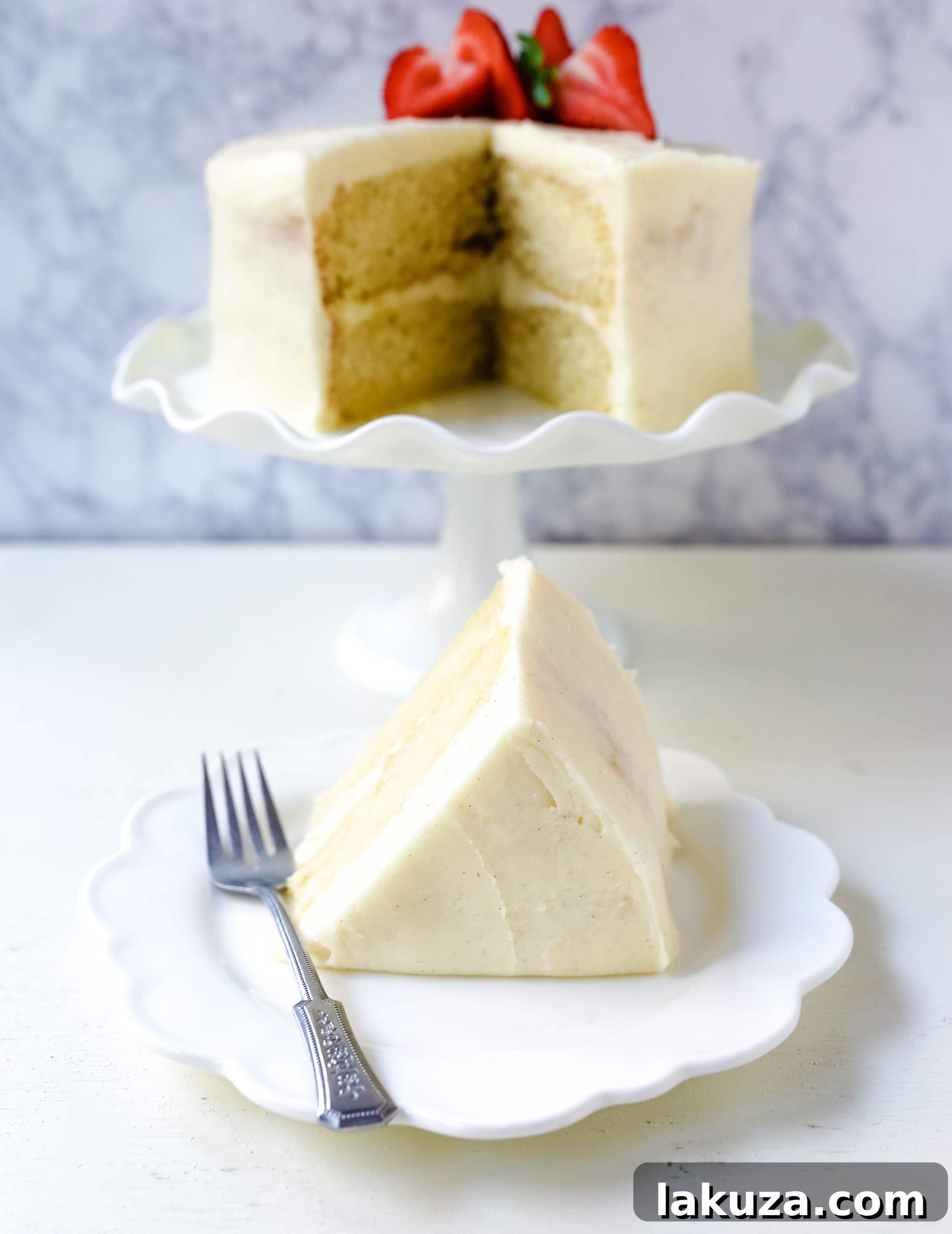 Delicious vanilla cake with a smooth frosting and delicate decorations.