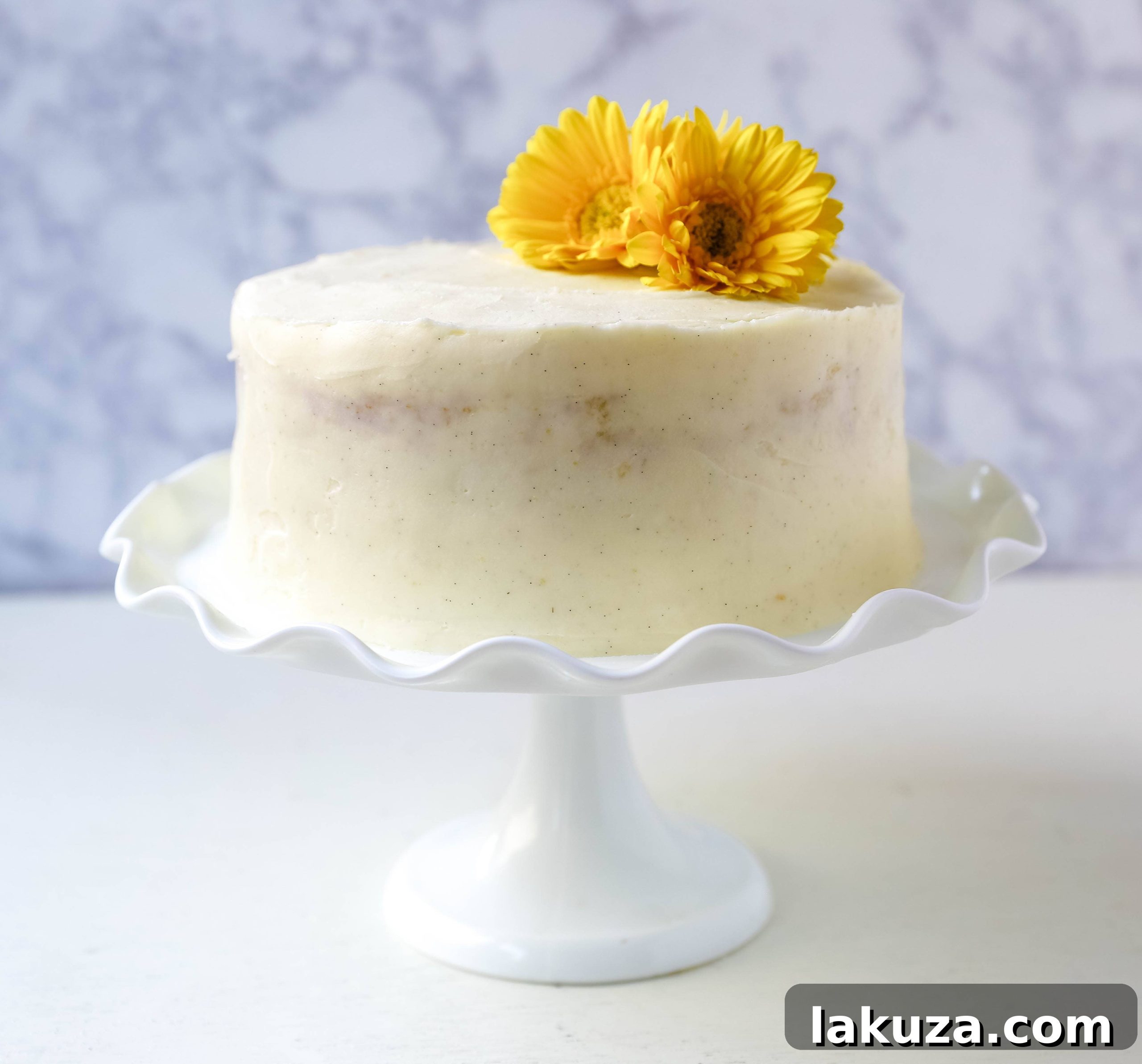 Festive vanilla cake with bright, elegant frosting, perfect for celebrations.