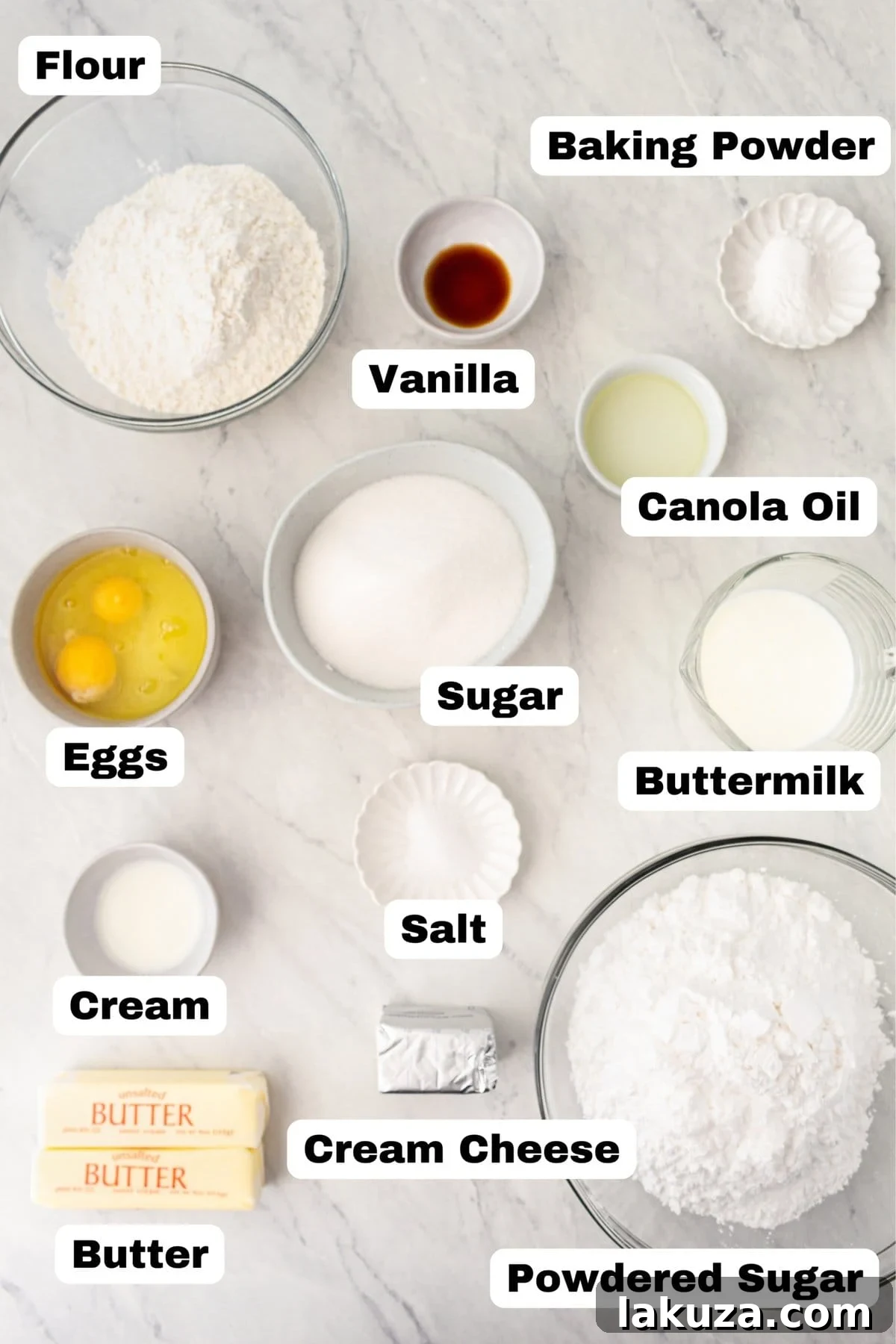 A selection of ingredients for homemade vanilla cake, including flour, sugar, and vanilla.