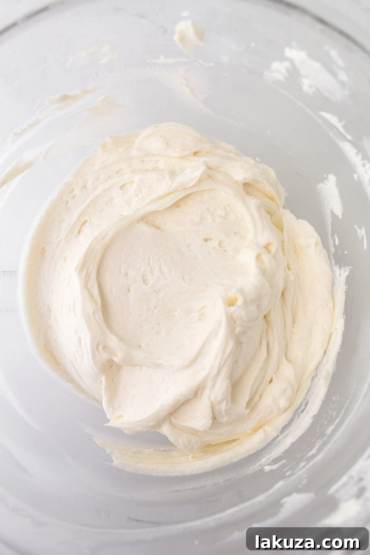 Ingredients laid out for vanilla buttercream frosting, including butter, powdered sugar, and vanilla bean paste.