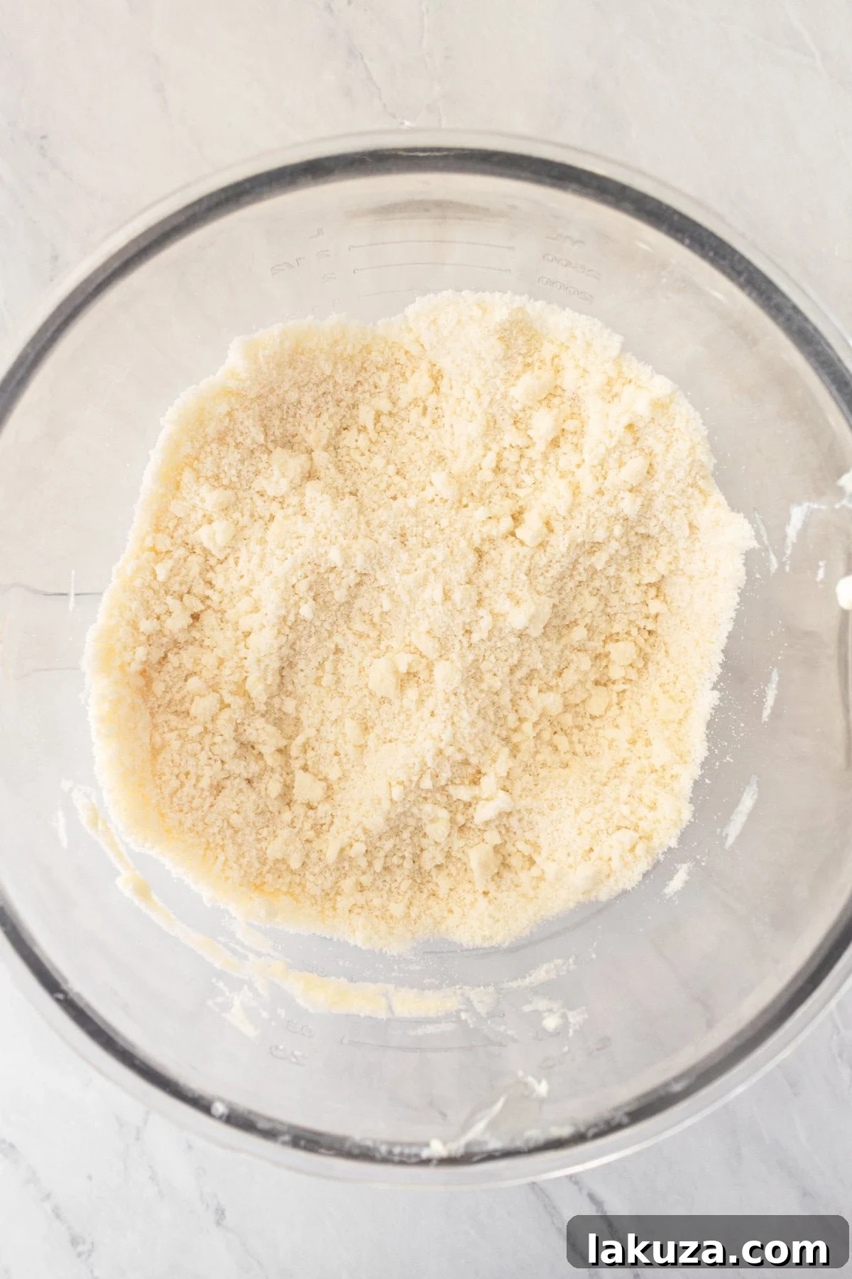 Beating butter into dry cake ingredients to create a coarse crumb texture.