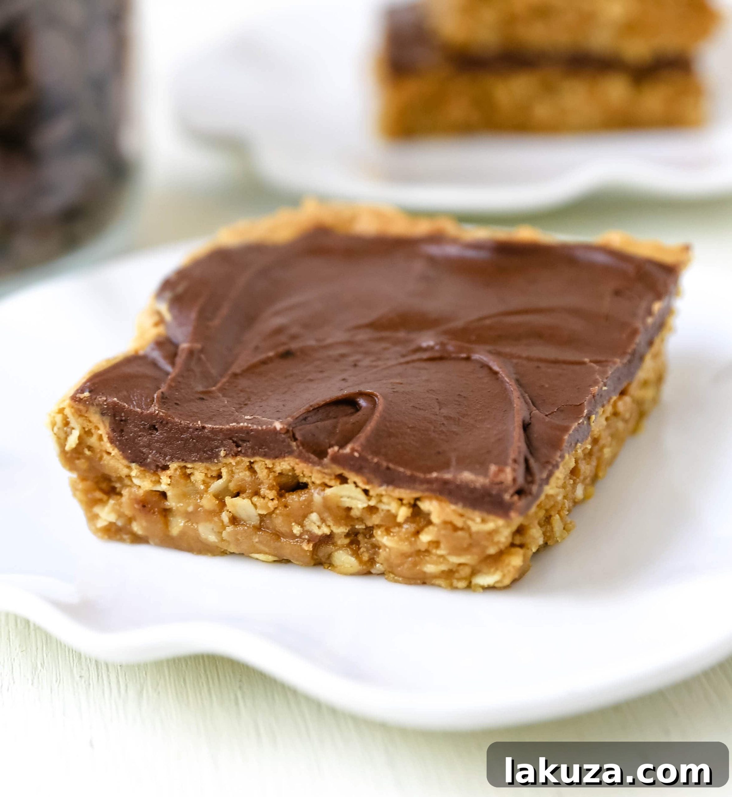 Chocolate Peanut Butter Cookie Bars freshly cut and arranged, highlighting the perfect layers of peanut butter cookie base and smooth chocolate topping.