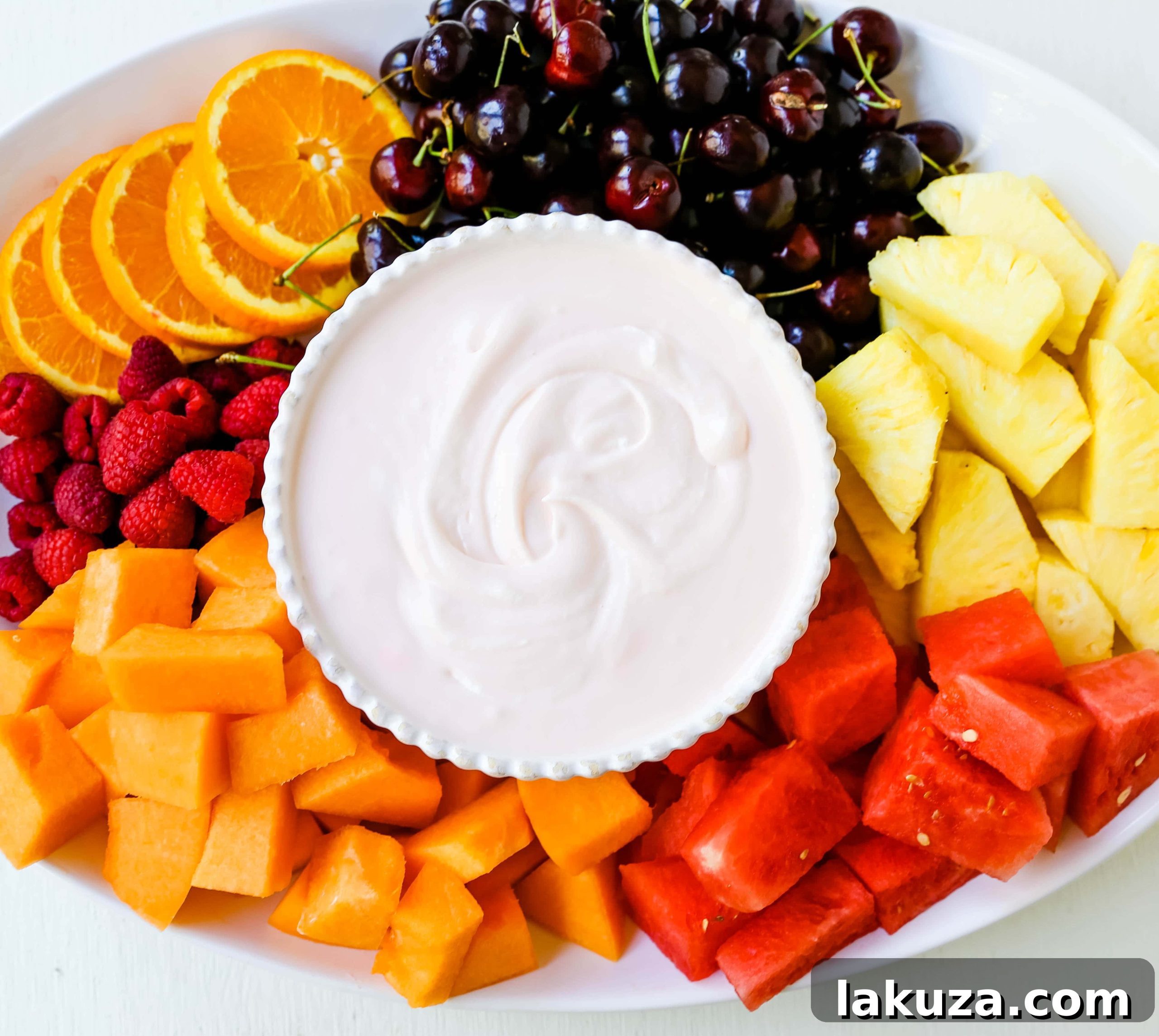Creamy Fruit Delight 2 Deliciously creamy and fluffy fruit dip, perfect for any gathering. Made with cream cheese, sweetened condensed milk, homemade whipped cream, and a hint of cherry juice.