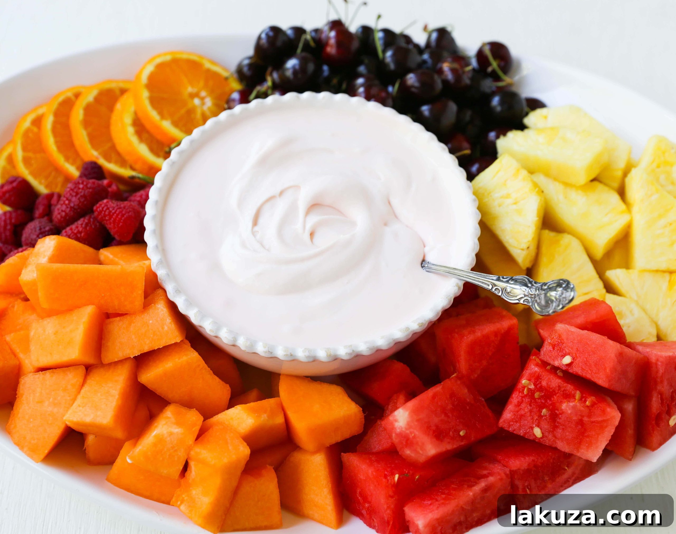 Creamy Fruit Delight 3 A close-up of a bowl of fluffy fruit dip, ready to be served with an assortment of colorful fresh fruits.