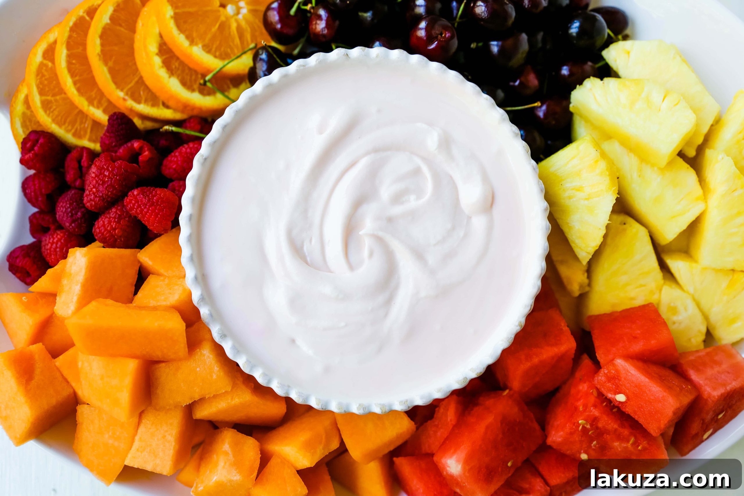 Creamy Fruit Delight 5 Ingredients for making the best fruit dip: cream cheese, sweetened condensed milk, and heavy cream on a counter.