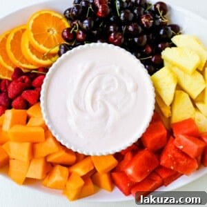 Creamy fruit dip in a bowl with fresh fruits.
