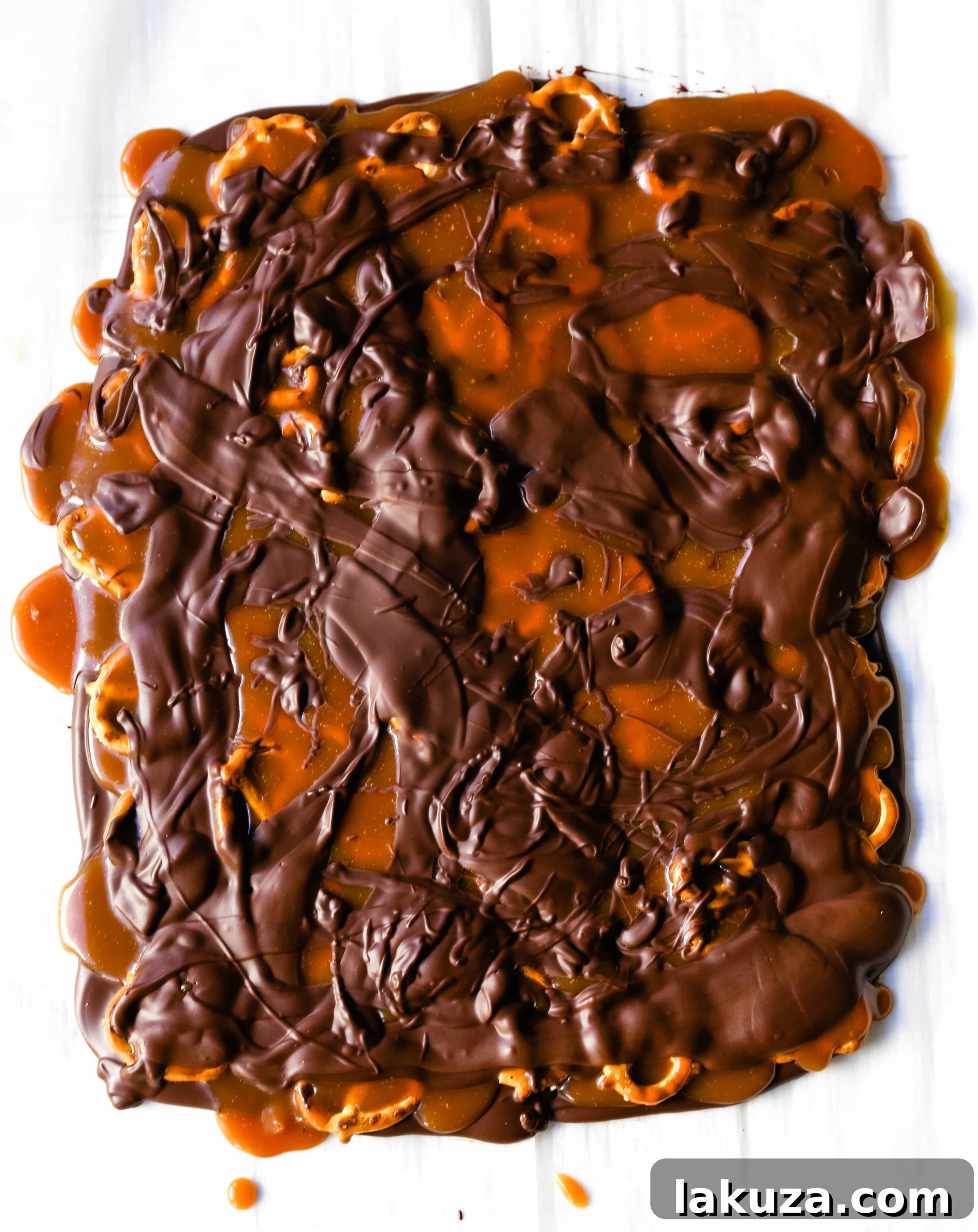 Salty-Sweet Chocolate Caramel Pretzel Crunch 3 Close-up of Homemade Chocolate Caramel Pretzel Bark, showcasing layers of dark and milk chocolate, golden caramel, and crunchy mini pretzels, a perfect balance of sweet and salty.