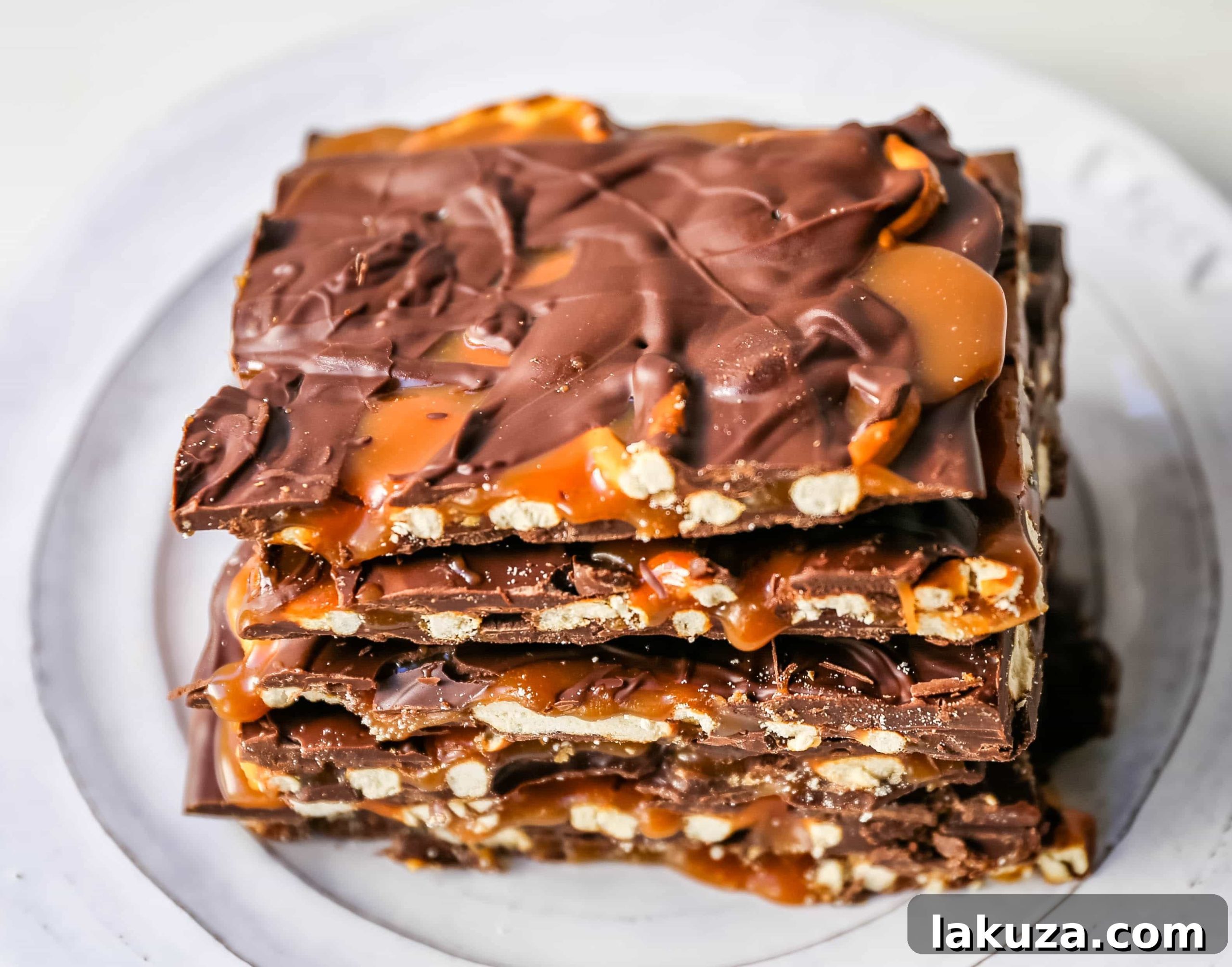 Salty-Sweet Chocolate Caramel Pretzel Crunch 4 Ingredients for Chocolate Caramel Pretzel Bark laid out: semi-sweet chocolate chips, milk chocolate chips, mini pretzels, and ingredients for homemade salted caramel (sugar, butter, heavy cream, sea salt).