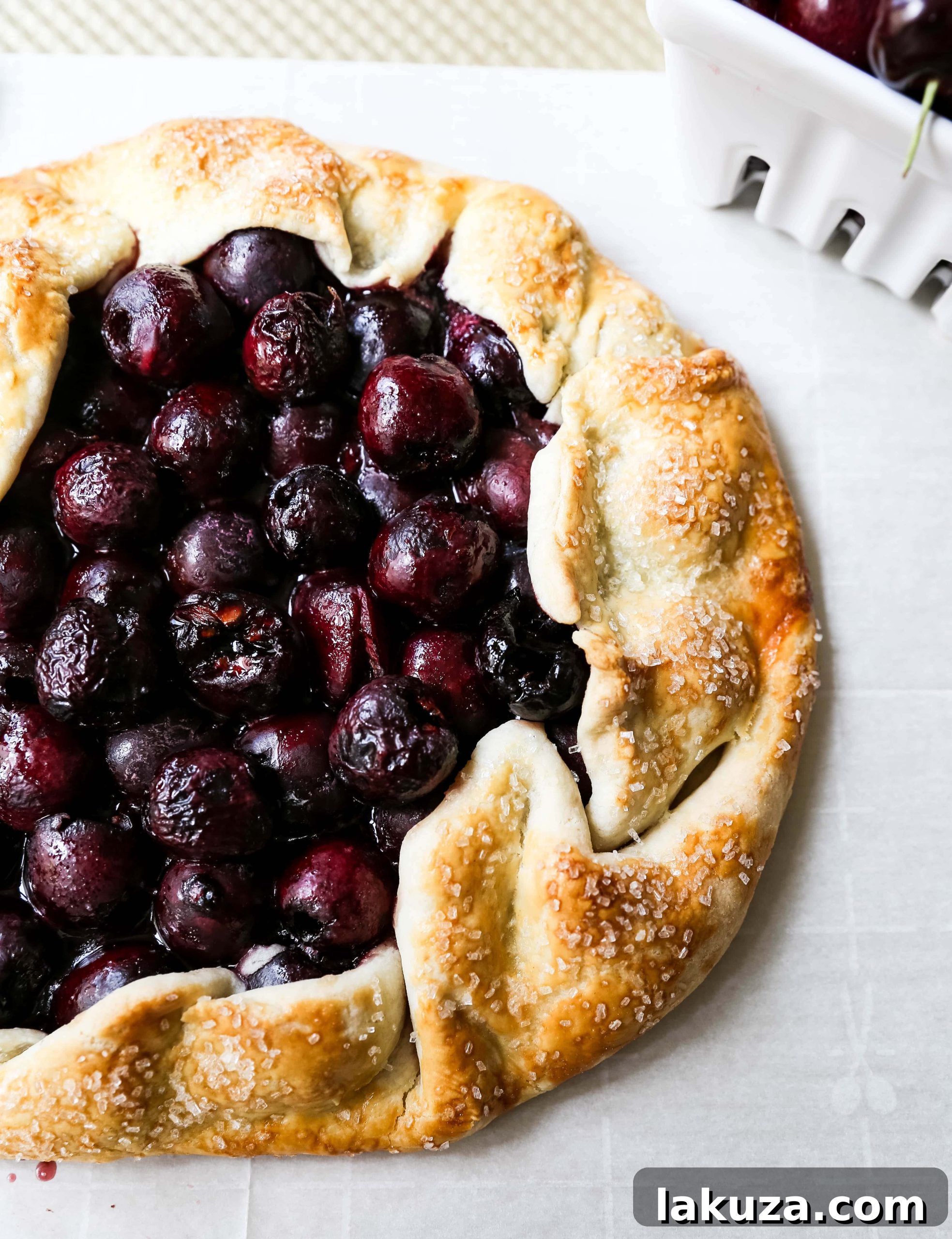 Close-up of a rustic cherry galette, showcasing the golden-brown crust and juicy cherry filling.