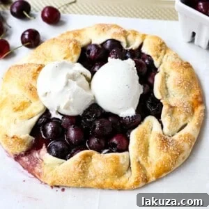 A thumbnail image of a baked cherry galette with a scoop of vanilla ice cream.