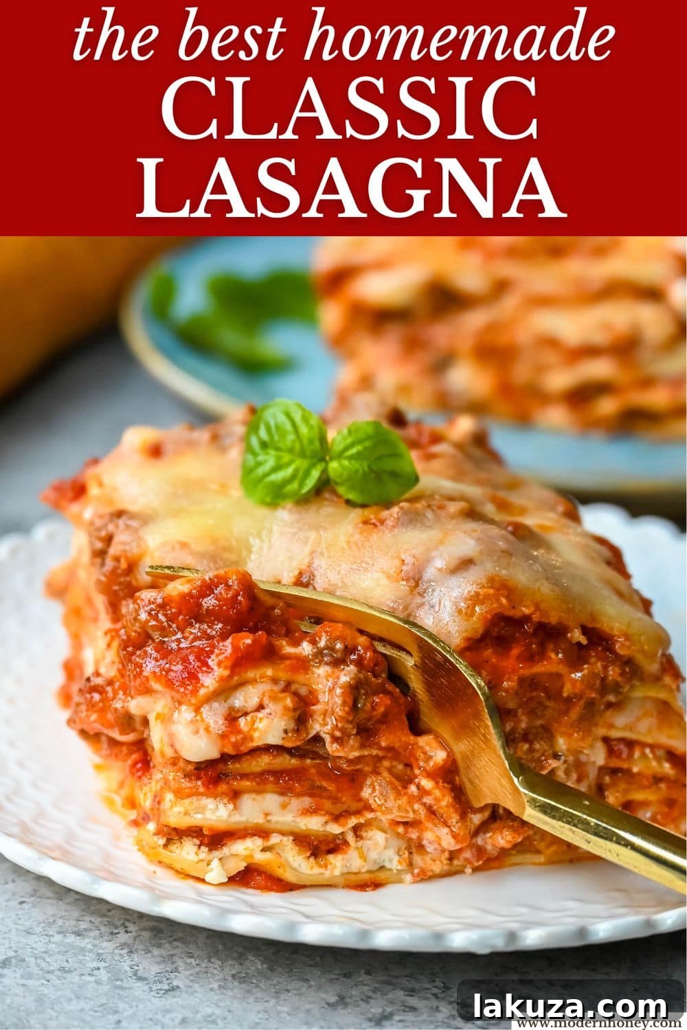 A beautifully presented slice of Classic Lasagna on a plate, showing all the perfect layers, with steam rising.