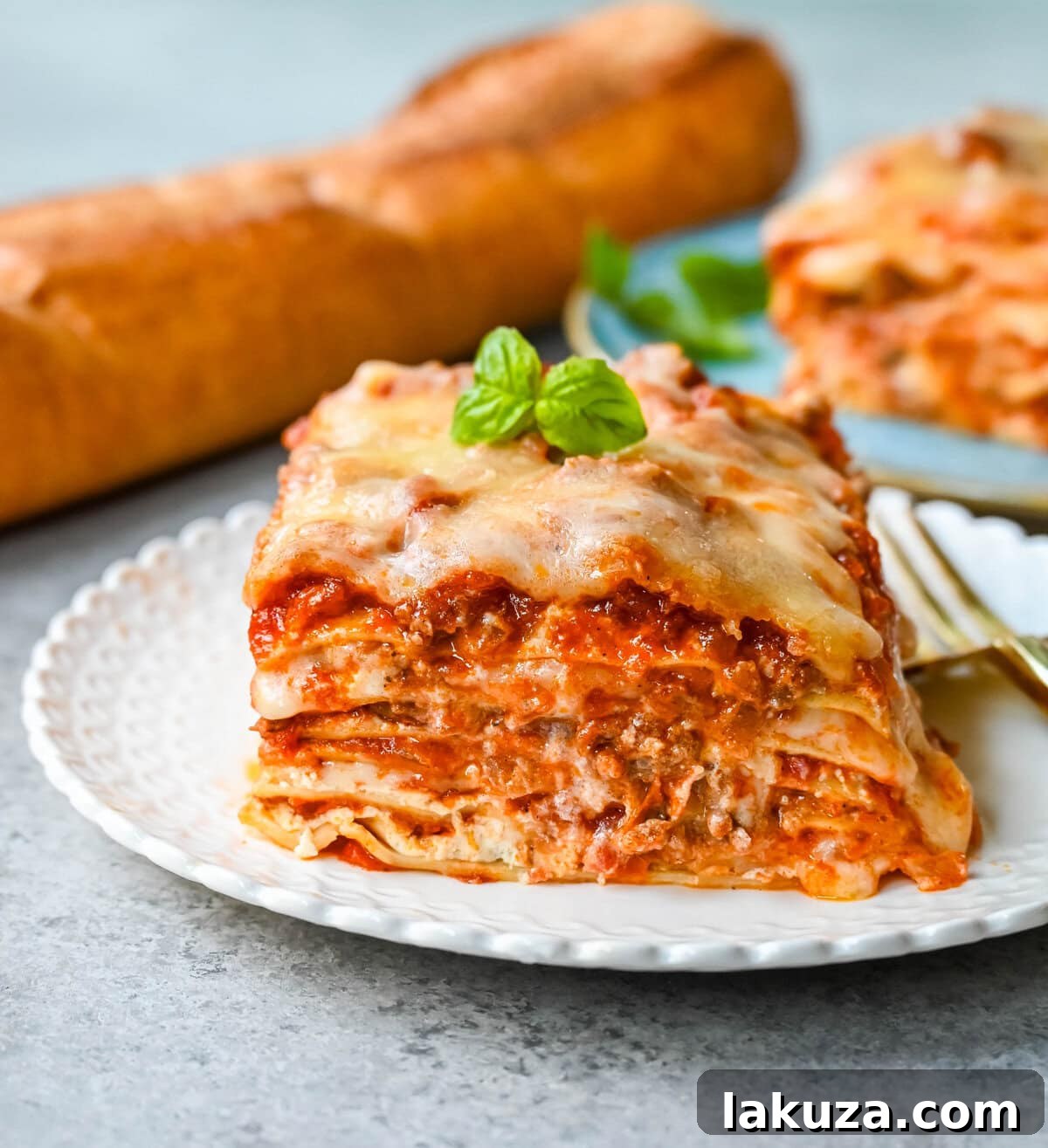 Classic lasagna layers showing the delicious parmesan ricotta cheese filling and robust meat sauce before baking.