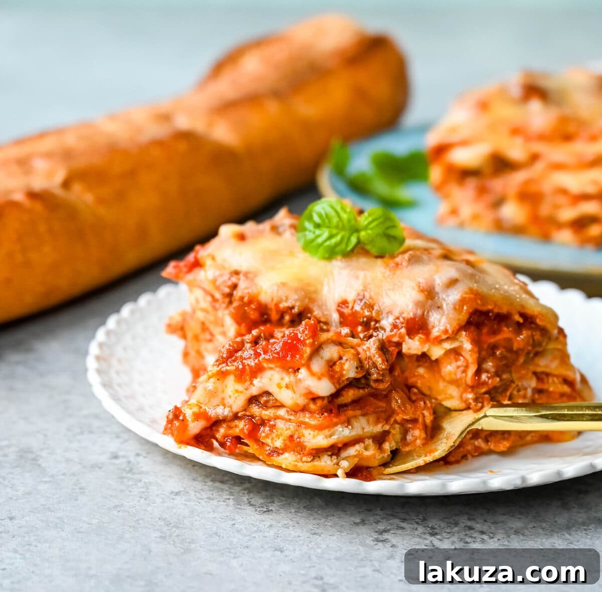 Fresh ingredients laid out for classic lasagna, including ricotta cheese, mozzarella, ground beef, and marinara sauce.
