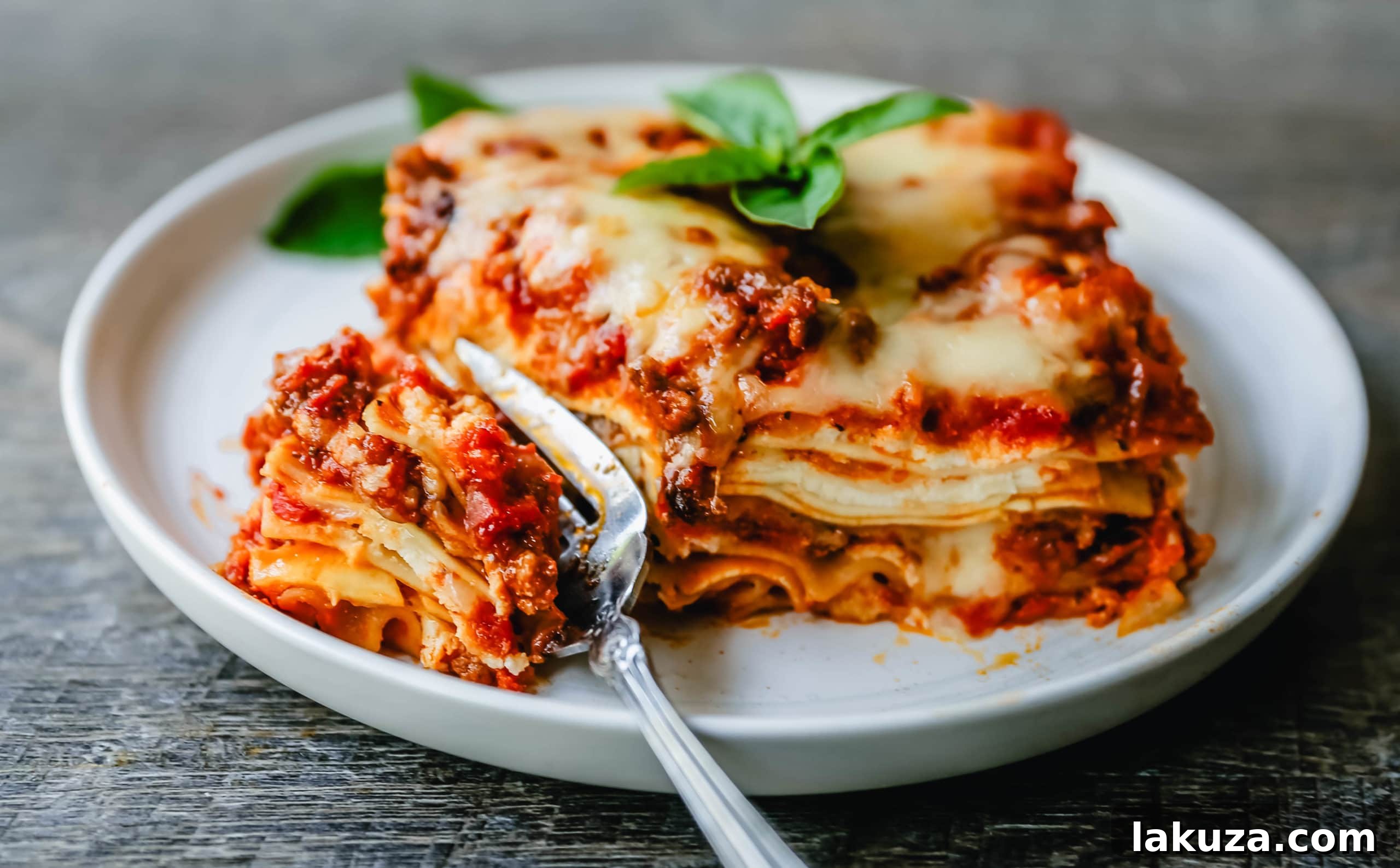 A perfectly baked slice of classic lasagna showcasing its rich layers of pasta, meat sauce, and cheese.