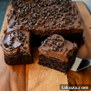 How to make the best chocolate zucchini cake with chocolate frosting. This frosted chocolate zucchini cake is the most moist, rich chocolate cake with the most decadent chocolate frosting. You will not even realize you are eating zucchini!