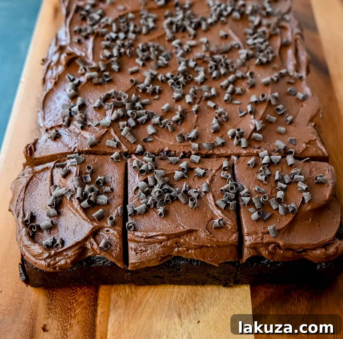 A beautifully frosted chocolate zucchini cake ready to be served, showcasing its moist texture and rich chocolate coating.