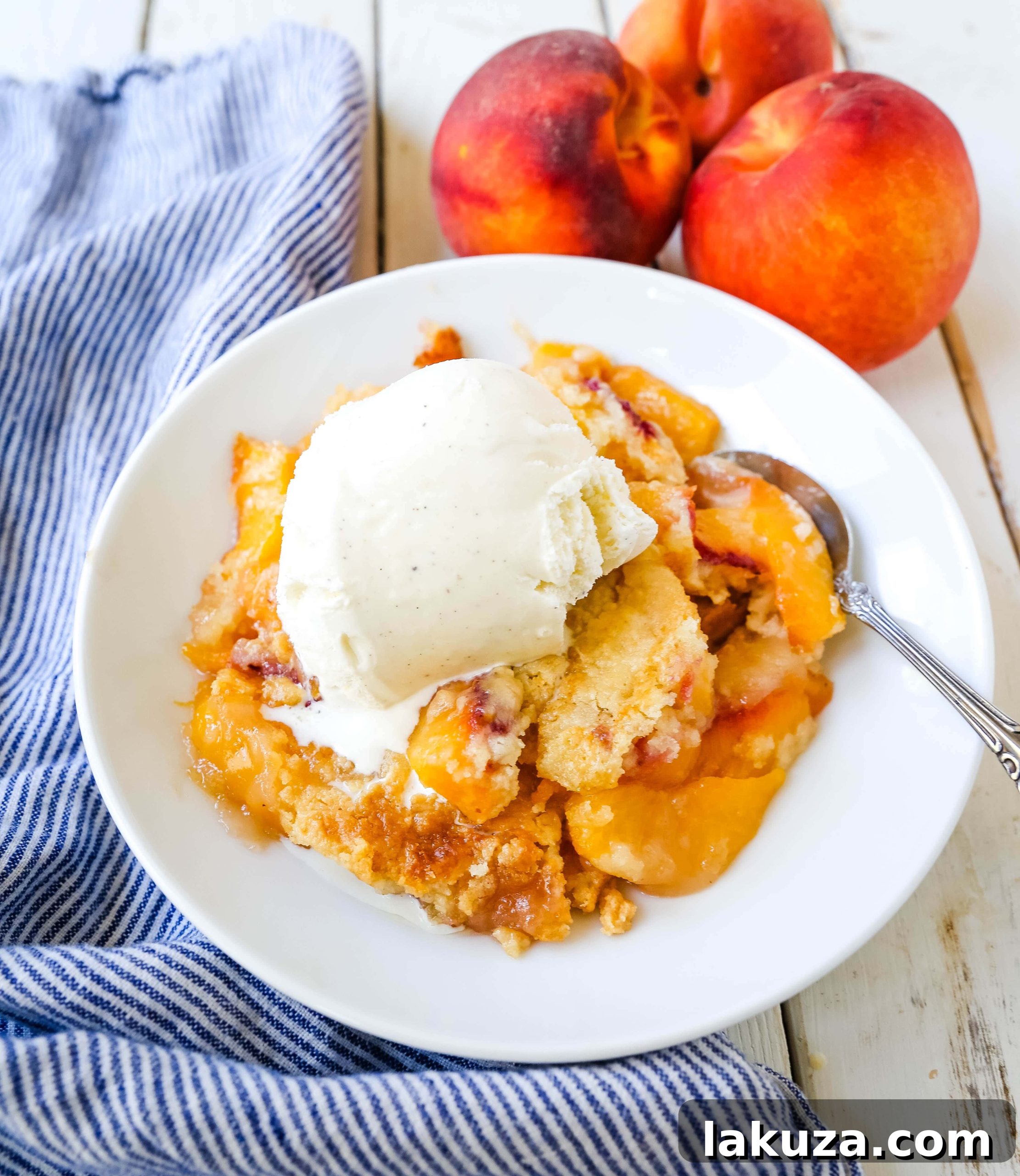 Close-up of a bubbling Peach Dump Cake, highlighting its perfect golden crust and juicy peach filling