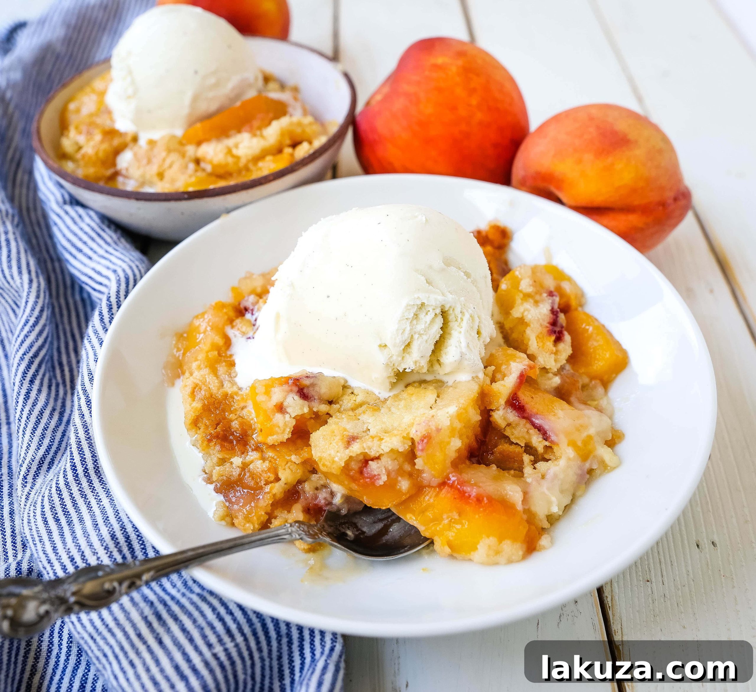 Overhead view of a Peach Dump Cake, showing the uncooked layers of peaches, dry cake mix, and thinly sliced butter