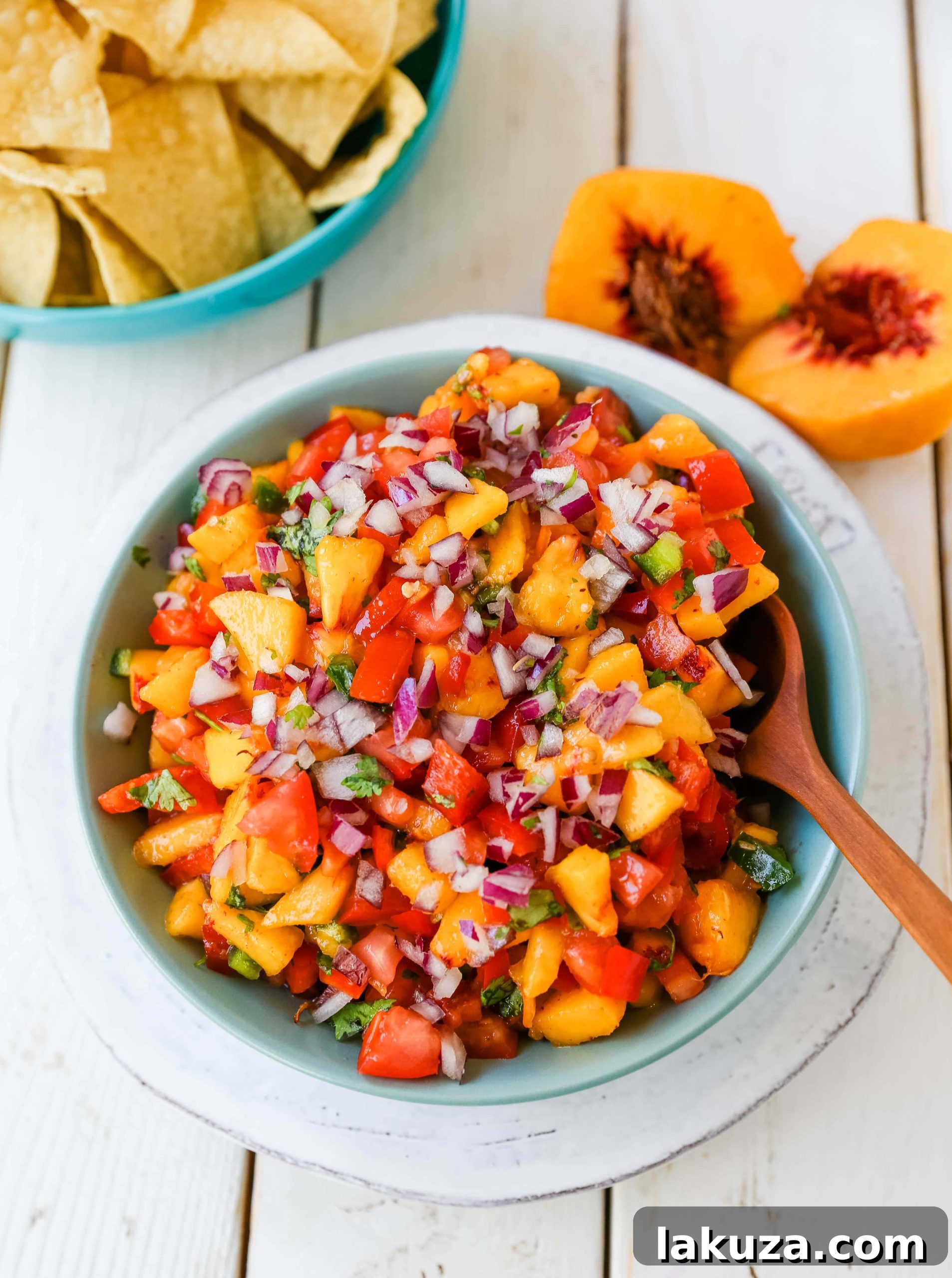 Fresh Peach Salsa with red pepper, jalapeño, red onion, tomatoes, cilantro, and fresh lime juice, perfect for chips, grilled chicken or pork.
