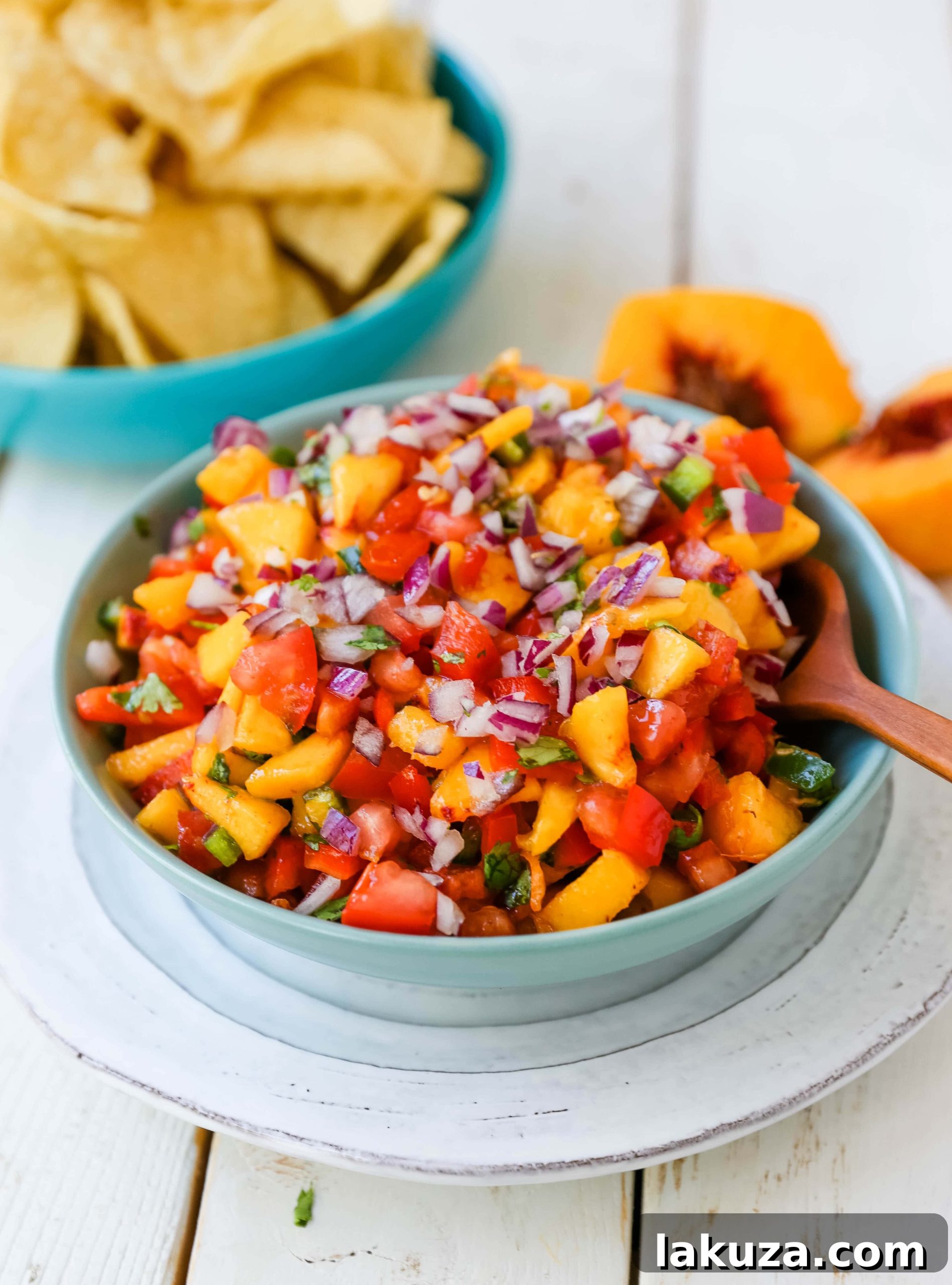 Close-up of Fresh Peach Salsa, highlighting the vibrant colors of peaches, red pepper, jalapeño, red onion, tomatoes, and cilantro.