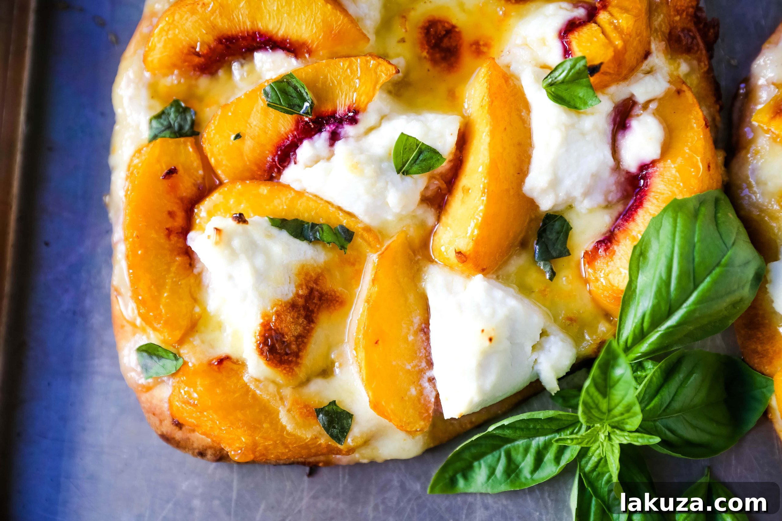 Sun-Kissed Peach & Basil Mozzarella Flatbread 5 Rustic close-up of Peach Basil Mozzarella Flatbread with melted cheese, juicy peach slices, and fresh basil, perfect for sharing or a quick summer meal. A signature dish from modernhoney.com.