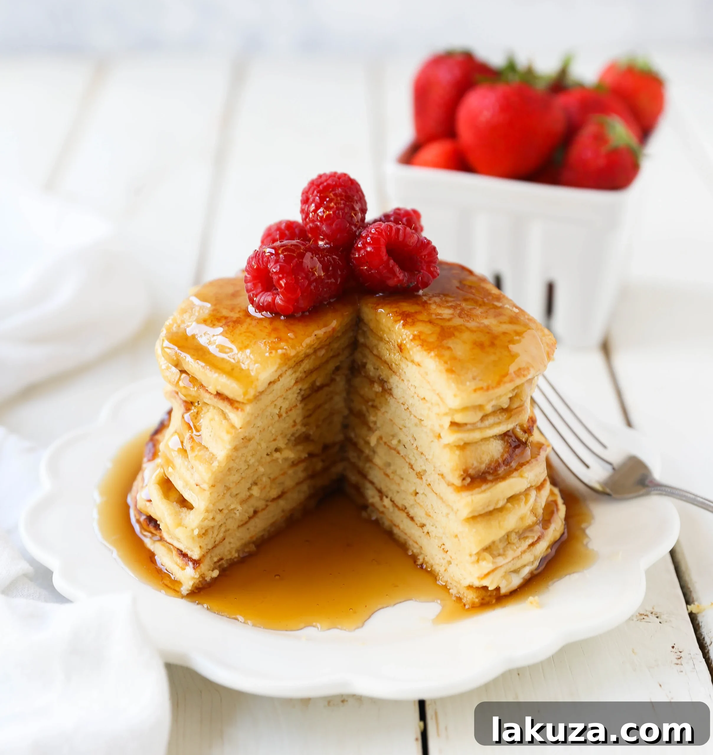 Stack of warm, golden-brown cottage cheese pancakes drizzled generously with maple syrup.