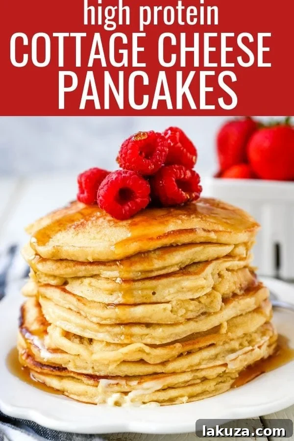 A beautifully composed shot of cottage cheese pancakes with various toppings like berries, maple syrup, and powdered sugar.