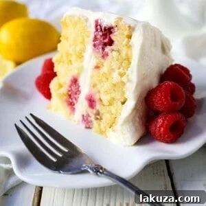 The Best Lemon Raspberry Cake. A light and fluffy lemon cake with fresh raspberries and a fresh lemon cream cheese frosting. A sweet and tangy lemon berry cake! #lemoncake #cake #lemonraspberrycake