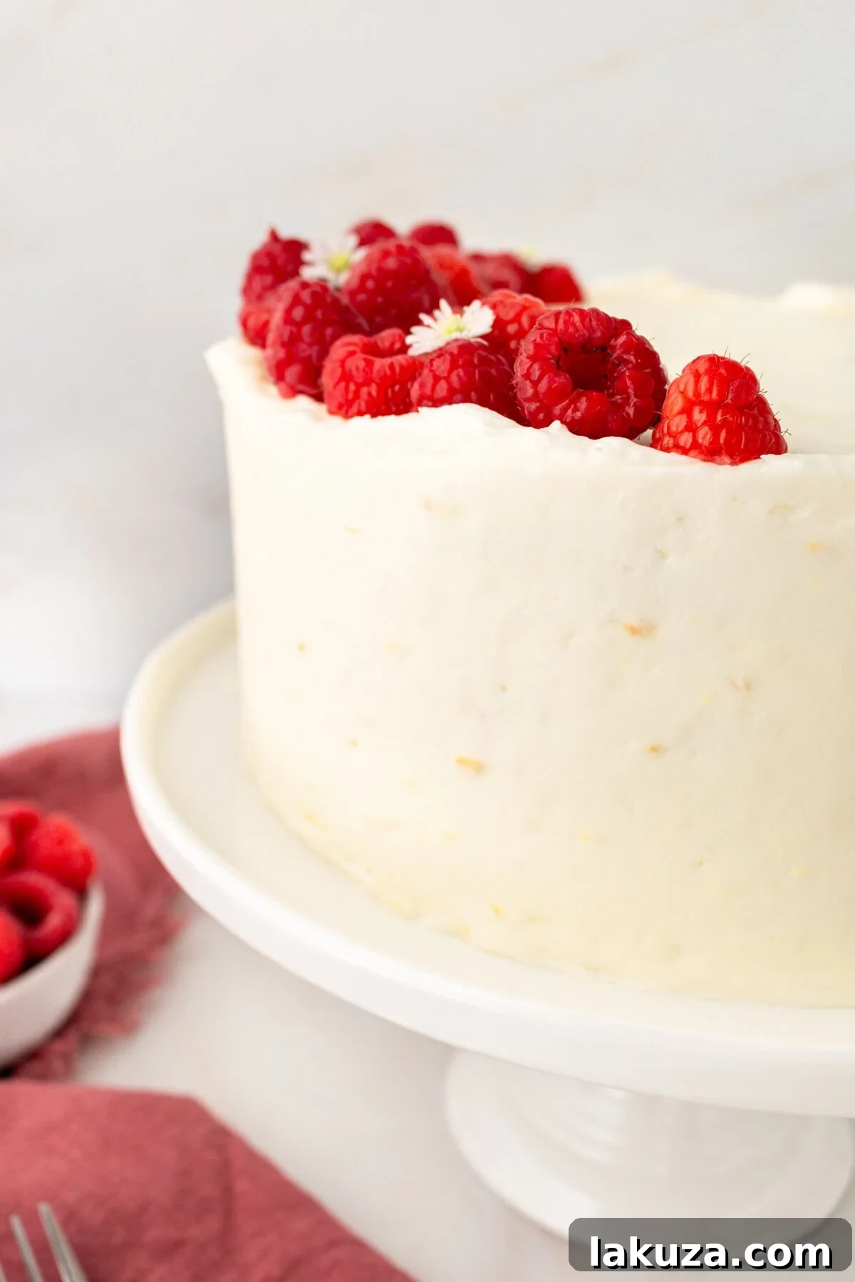 Lemon Raspberry Cake with Lemon Cream Cheese Frosting. A light and fluffy lemon cake with fresh raspberries and a fresh lemon cream cheese frosting. A sweet and tangy lemon berry cake!