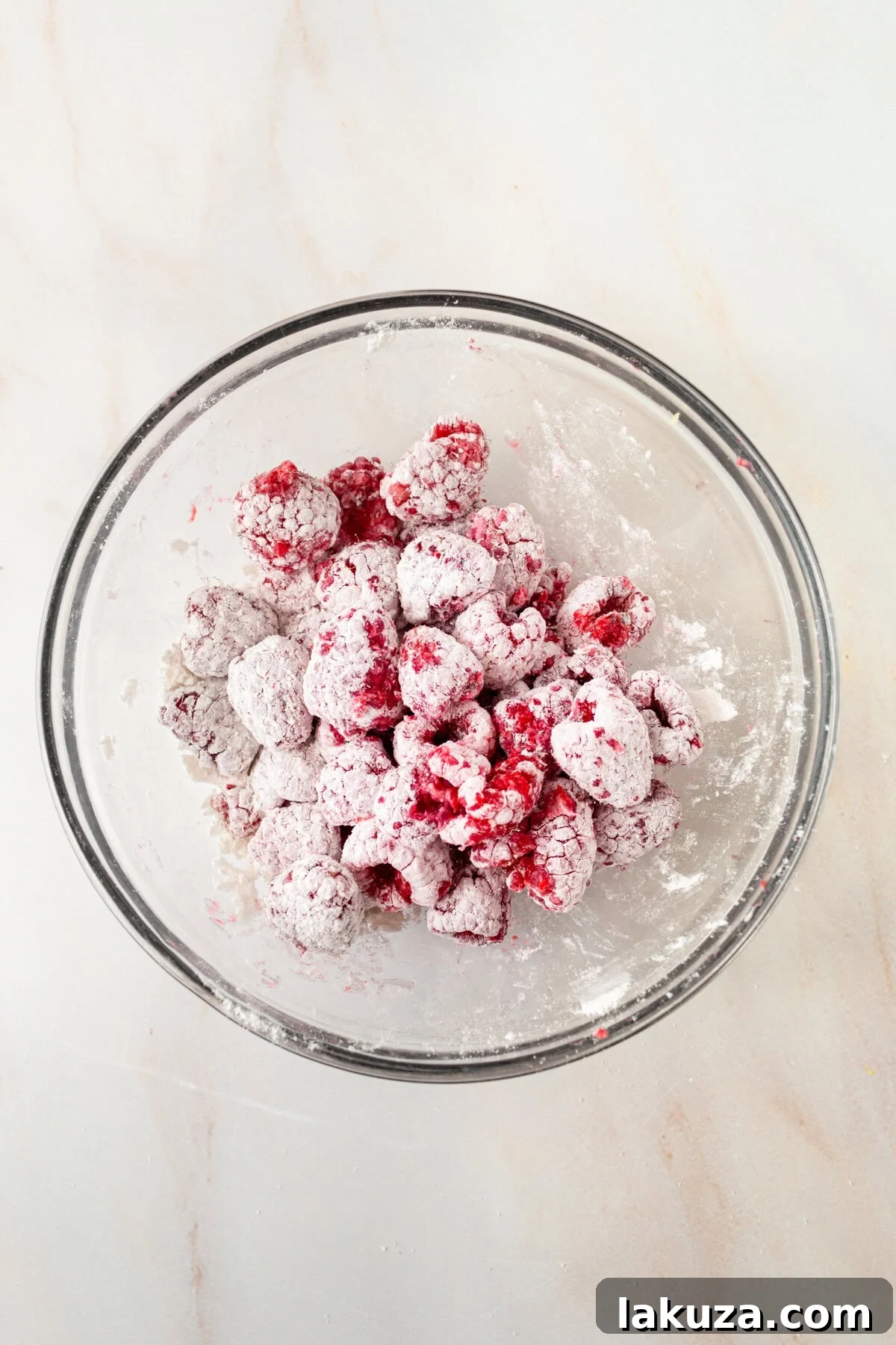Coat raspberries with flour to keep from sinking to the bottom of the cake