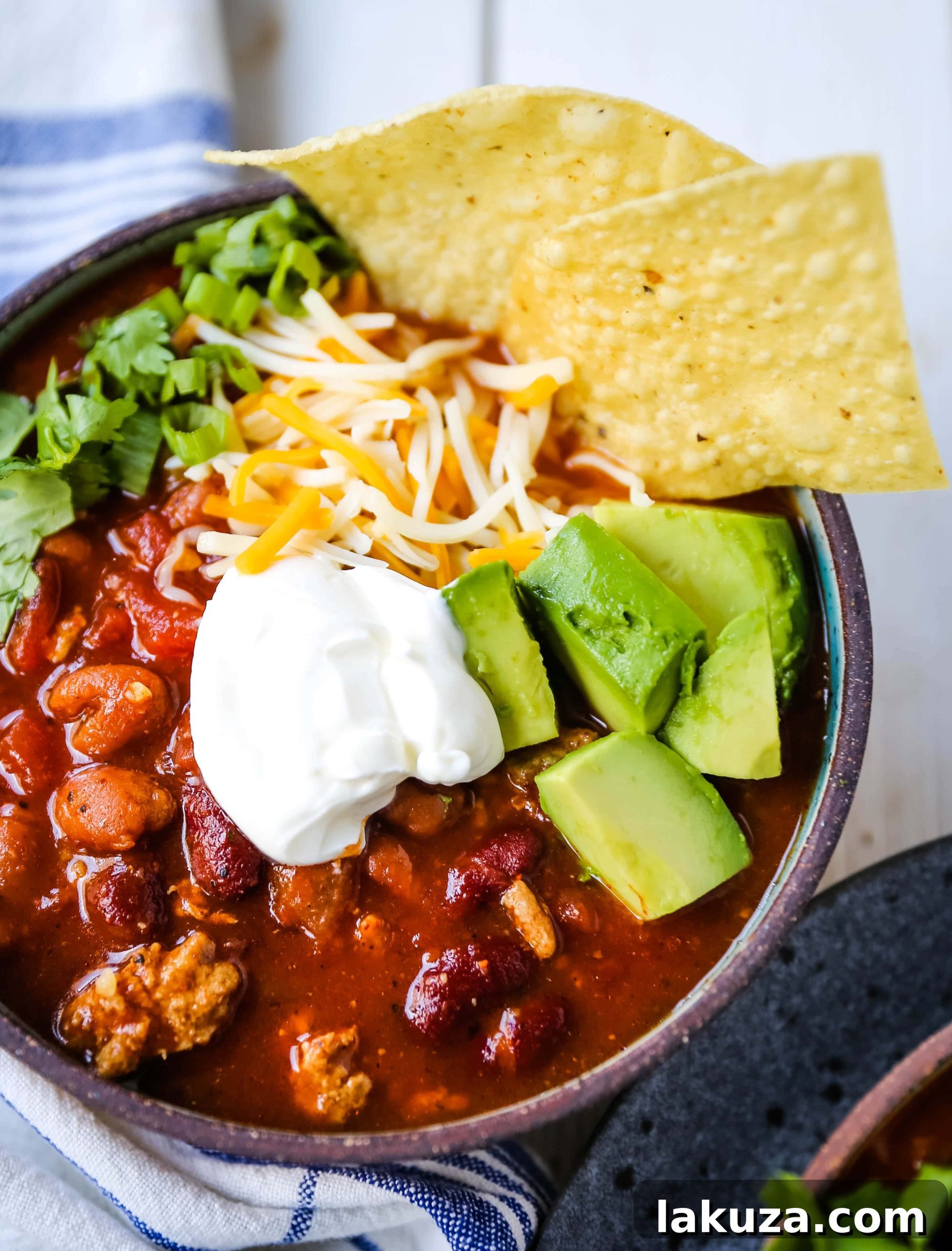 A close-up of a pot of simmering turkey chili, rich in color and texture, ready to be served
