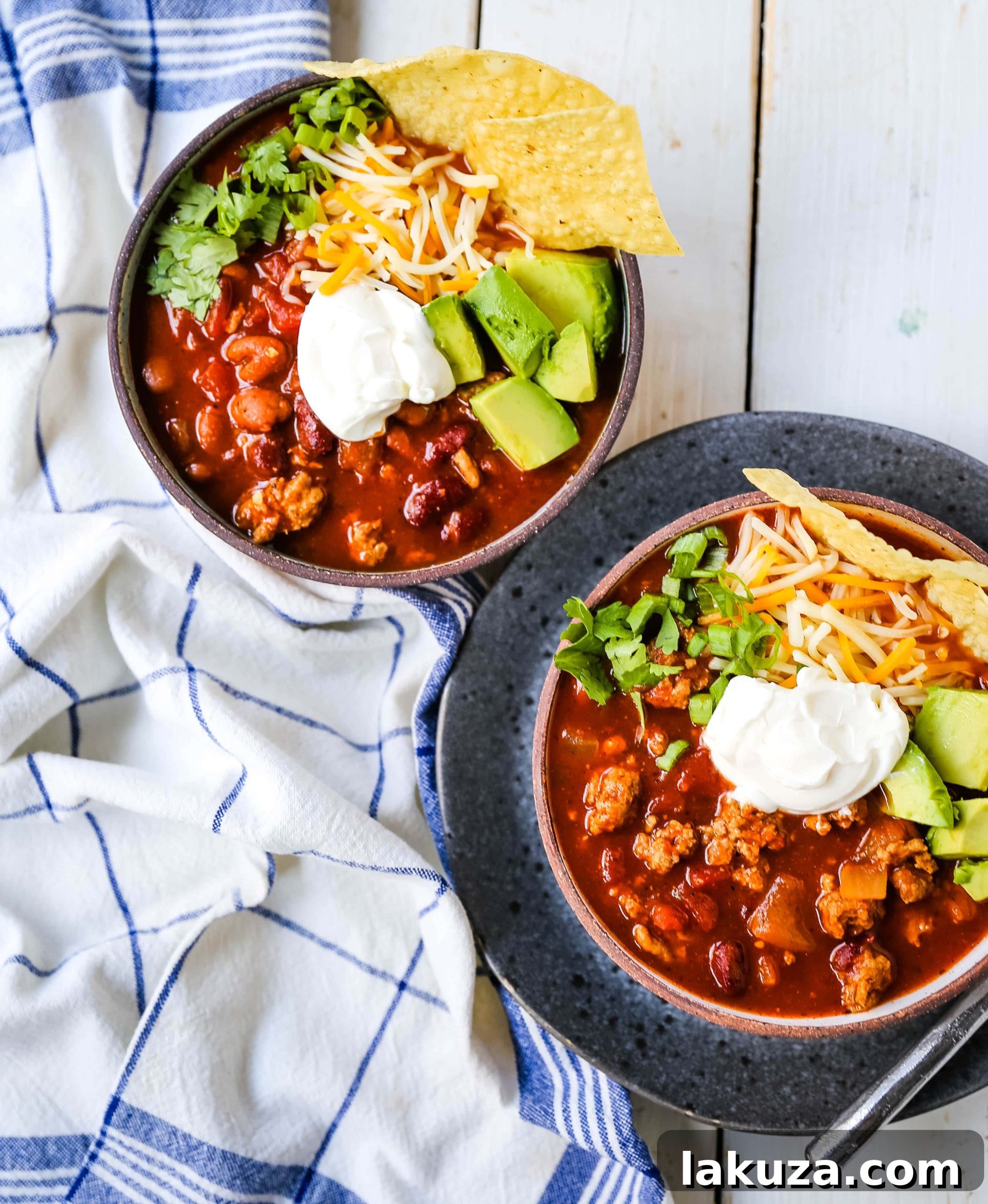 A bowl of delicious turkey chili, garnished with fresh cilantro and a dollop of sour cream, ready for enjoyment