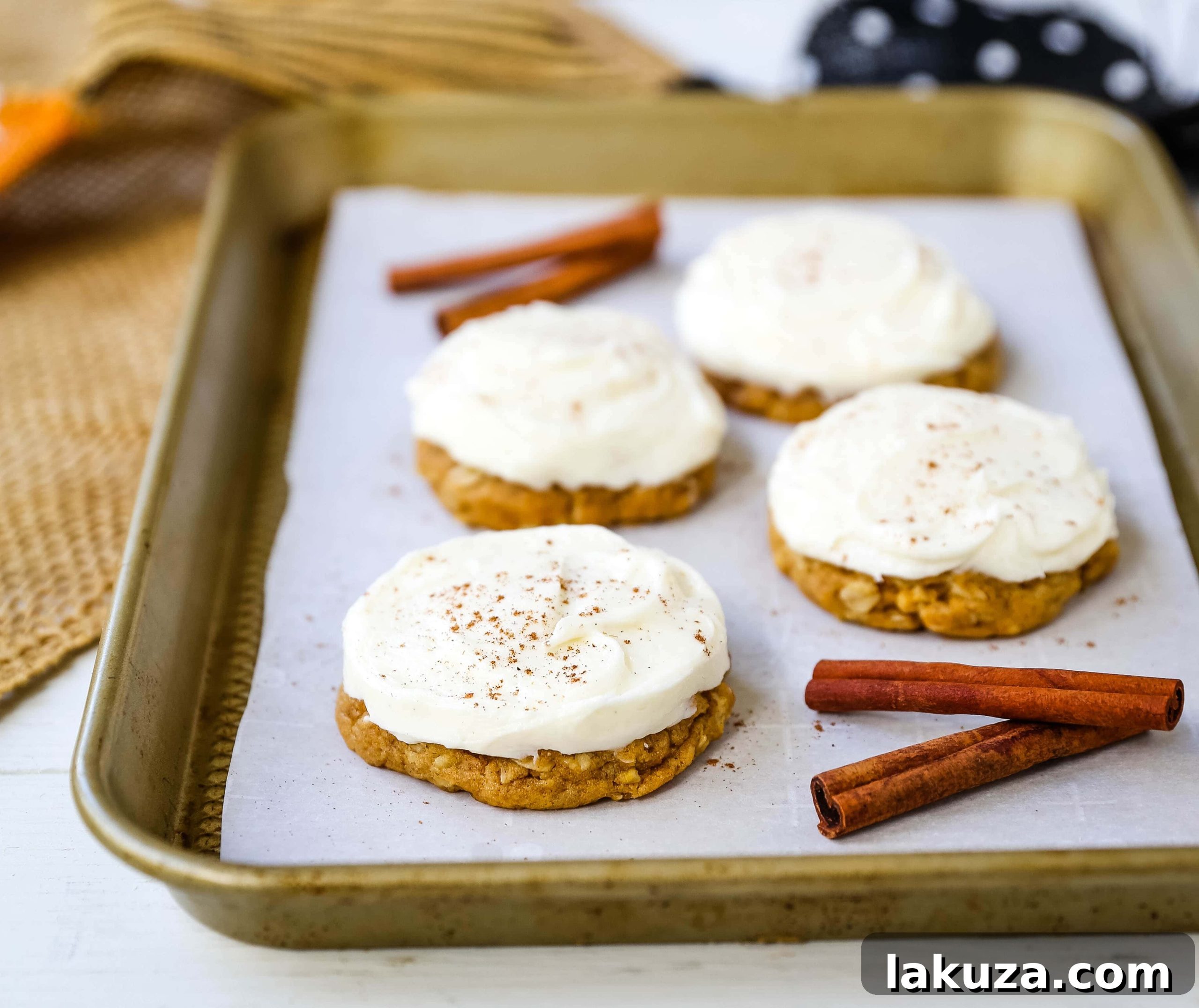 Decadent Pumpkin Cookies with Cream Cheese Frosting 3 Close-up of fluffy cream cheese frosted pumpkin cookies on a cooling rack