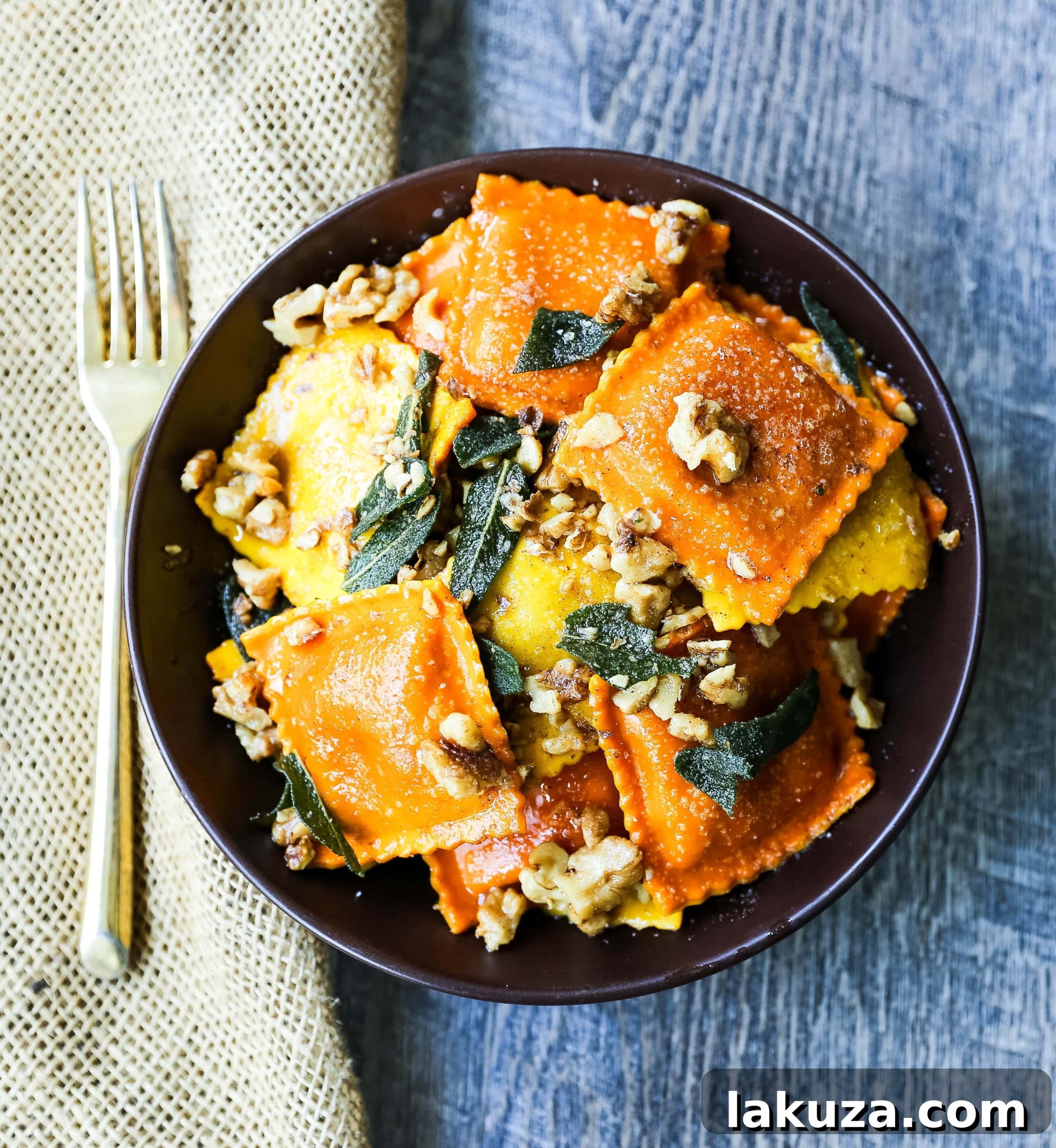 Nutty Brown Butter Sage Ravioli 2 Delicious fresh ravioli with browned butter, crispy sage, and toasted walnuts in a rustic bowl, perfect for a cozy meal.