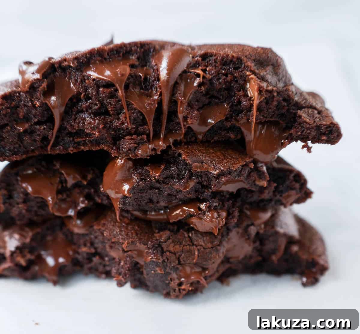 A stack of perfectly baked double chocolate chip cookies, with visible pools of melted chocolate chips, resting on a rustic wooden surface, highlighting their rich, decadent appeal.