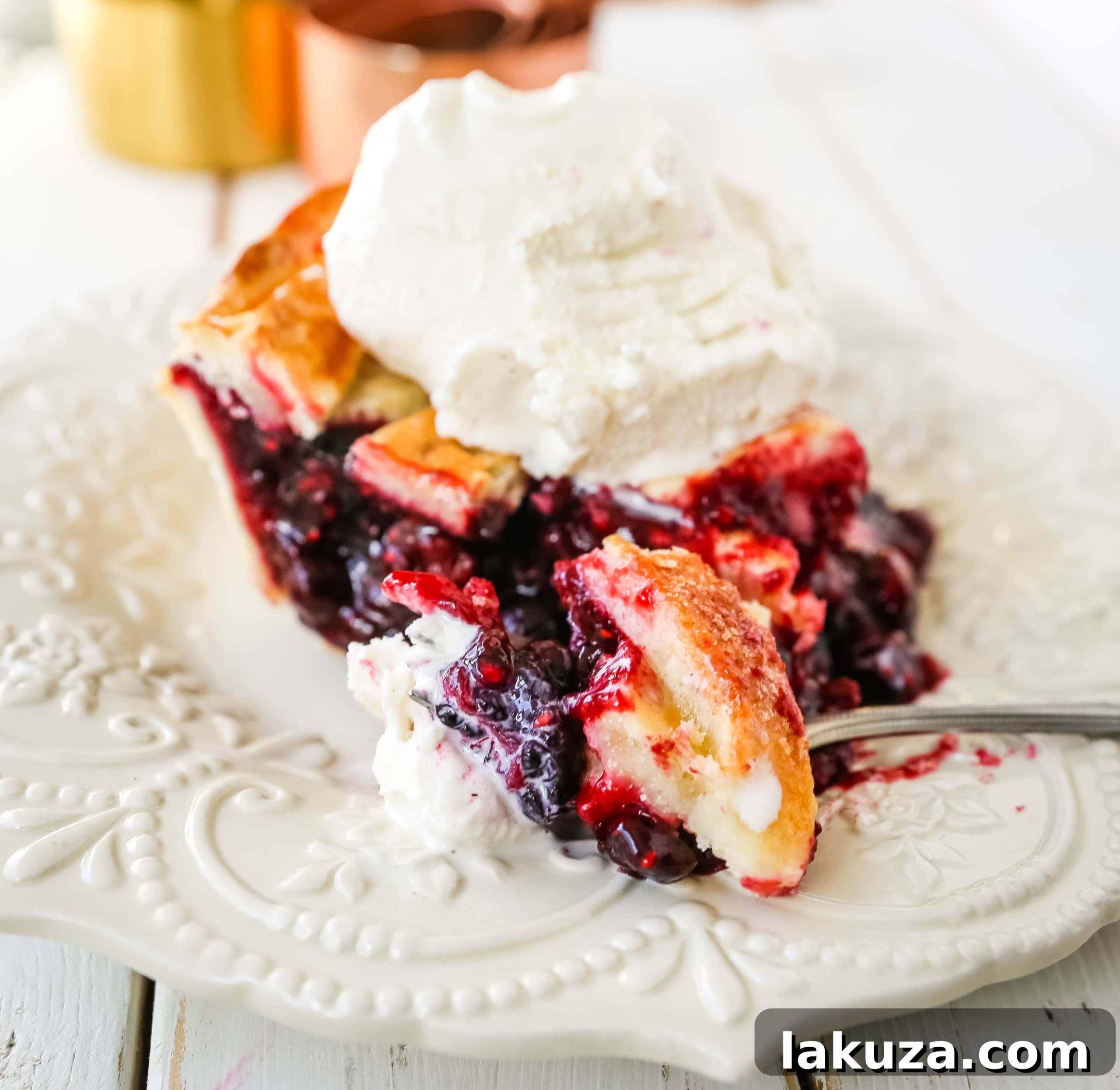Berry Burst Pie 6 A warm Triple Berry Pie, fresh out of the oven, with its golden crust and bubbly berry filling, ready to be cooled and served.