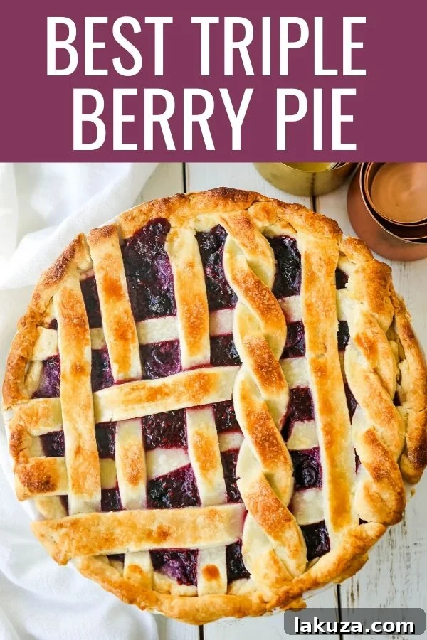 Berry Burst Pie 7 A stunning Triple Berry Pie, perfectly baked with a golden-brown crust, displayed on a wooden surface, ready to be a centerpiece dessert.