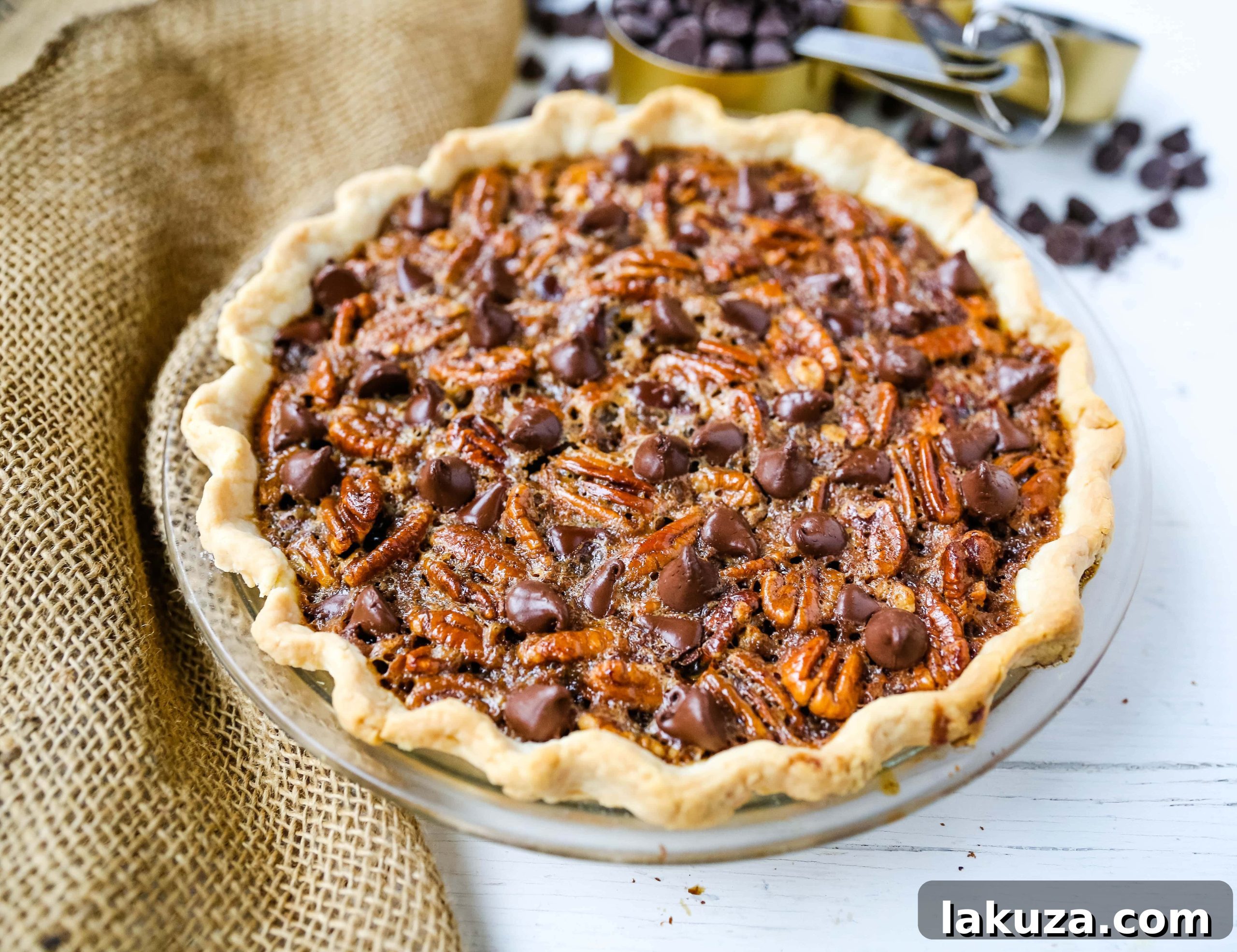 A slice of Chocolate Pecan Pie with a dollop of whipped cream on top