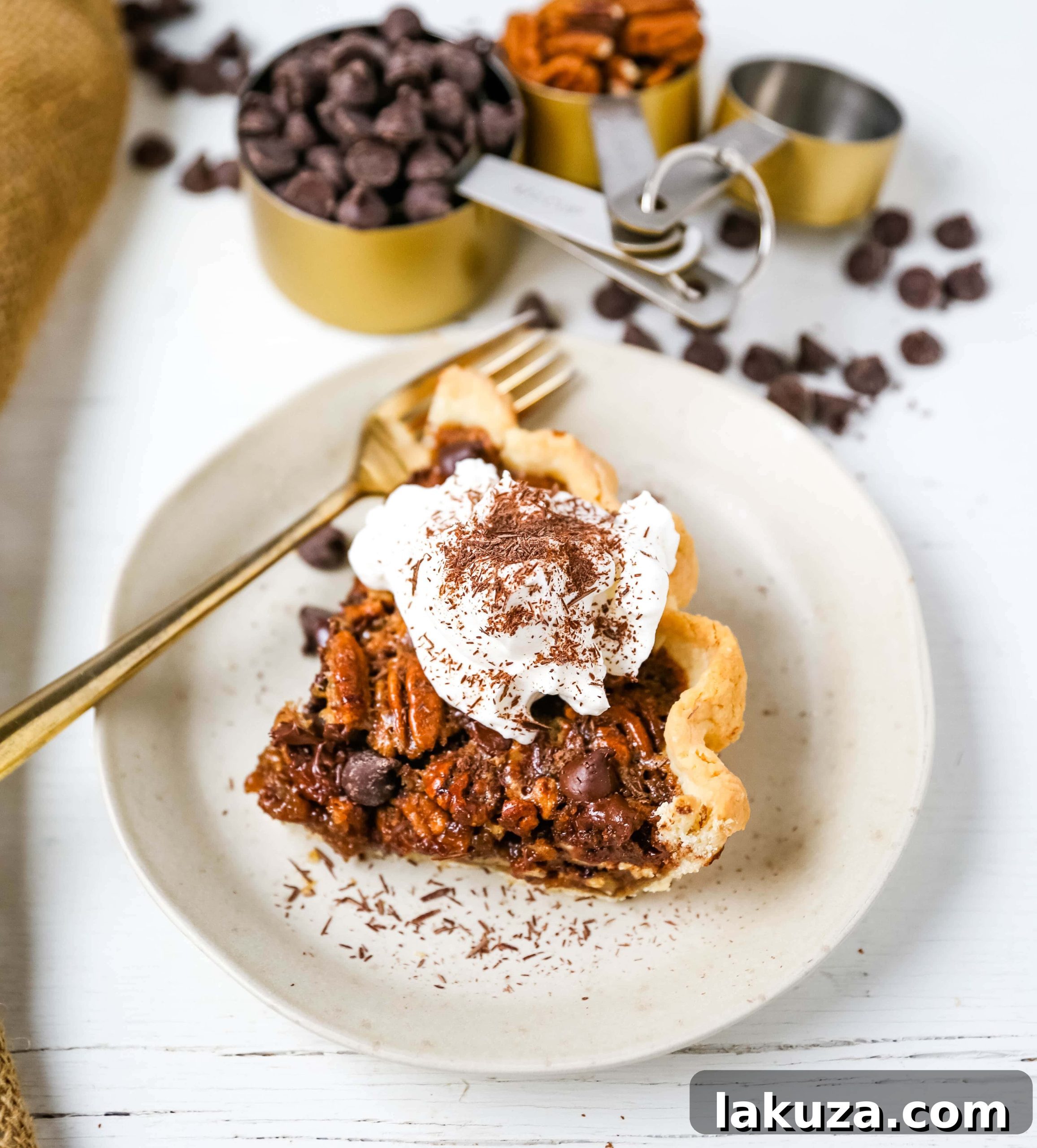Another close-up of a slice of Chocolate Pecan Pie, garnished with fresh whipped cream