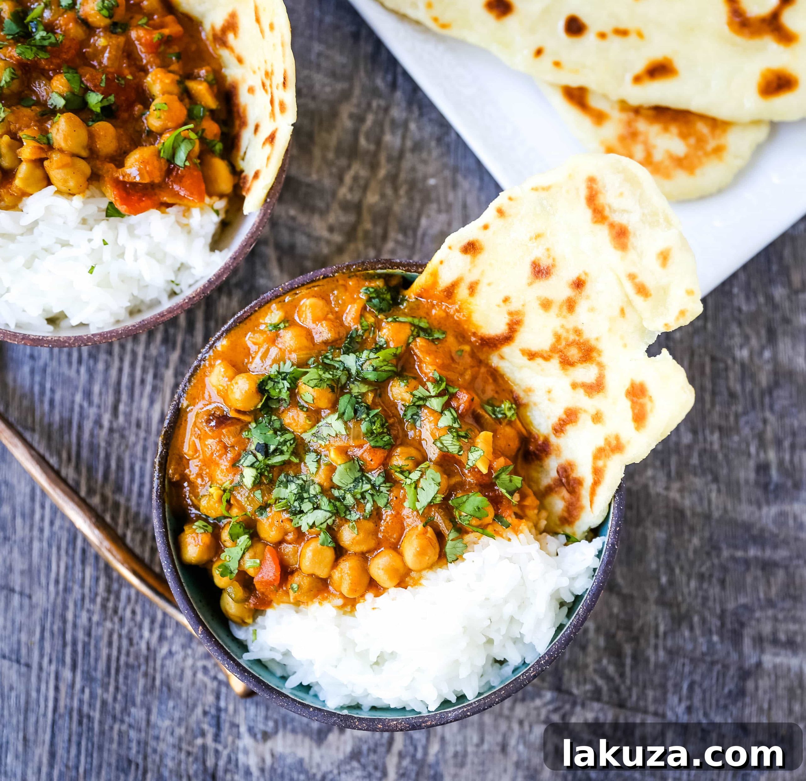 Fresh ingredients like onion, garlic, and ginger being sautéed in a pan, forming the aromatic base of the chickpea curry.