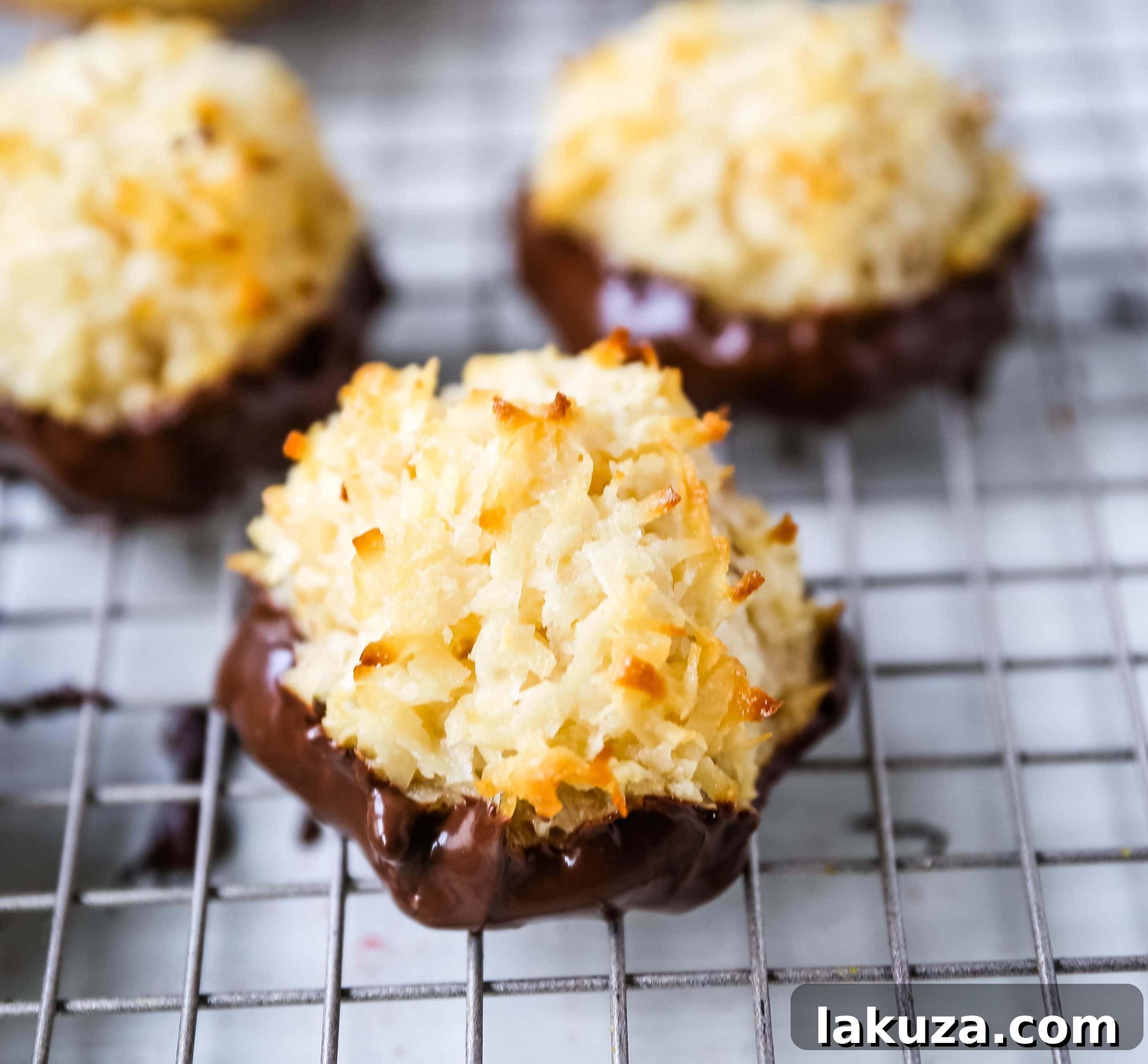 Expert guide to making the best coconut macaroons: soft, chewy, sweet, and gluten-free cookies. Perfect for dipping in dark chocolate for an enhanced treat. Modern Honey recipe.