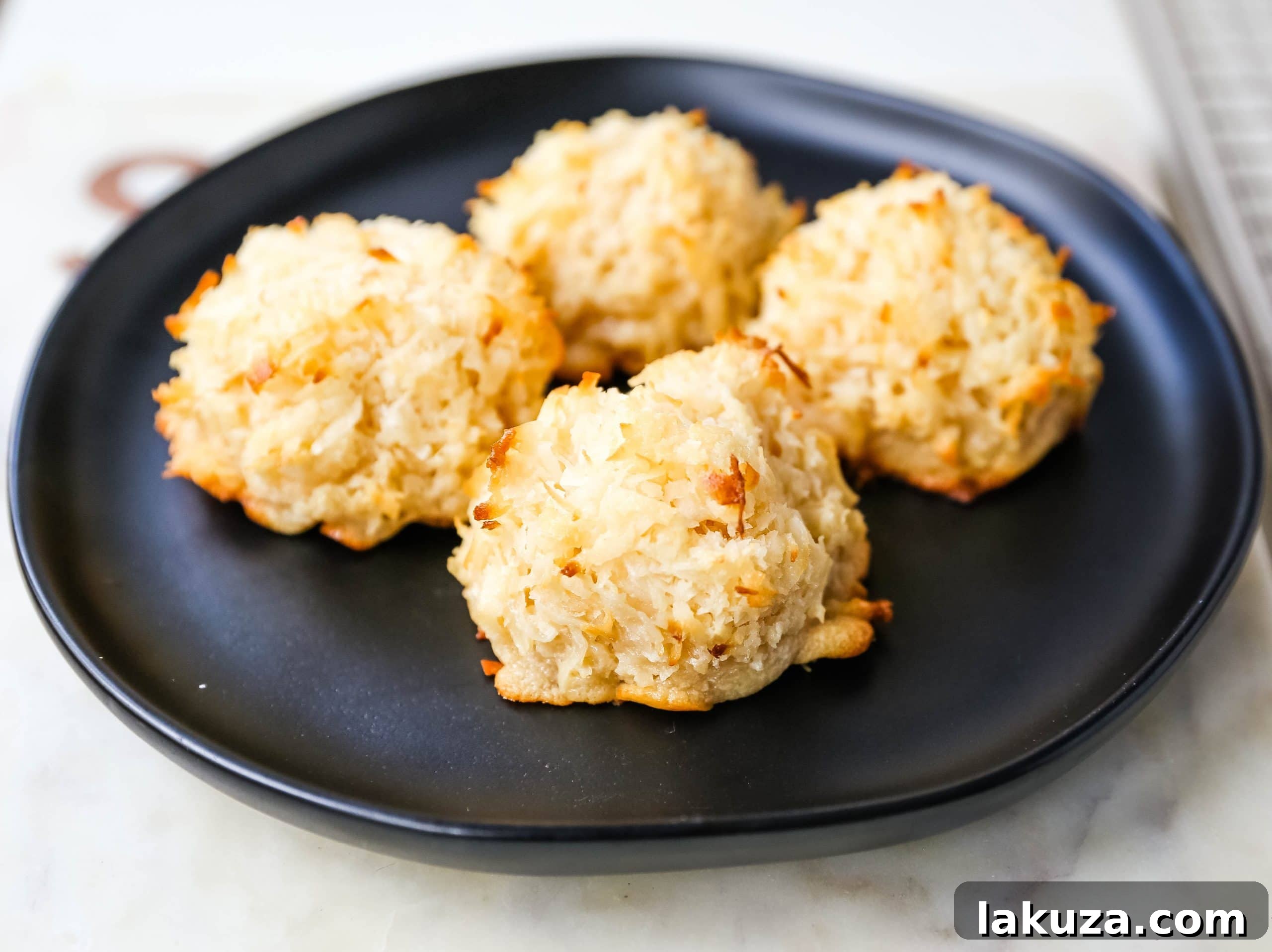 Detailed instructions for making the best soft, chewy, sweet, and gluten-free coconut macaroons. Includes tips for dipping them in dark chocolate for a perfect treat. Modern Honey's top recipe.