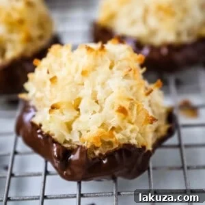 The Best Coconut Macaroons. Soft chewy sweet coconut macaroons are the perfect gluten-free cookie. How to make the perfect coconut macaroons dipped in dark chocolate. www.modernhoney.com #macaroons #coconutmacaroons #macaroon #christmascookie #christmascookies